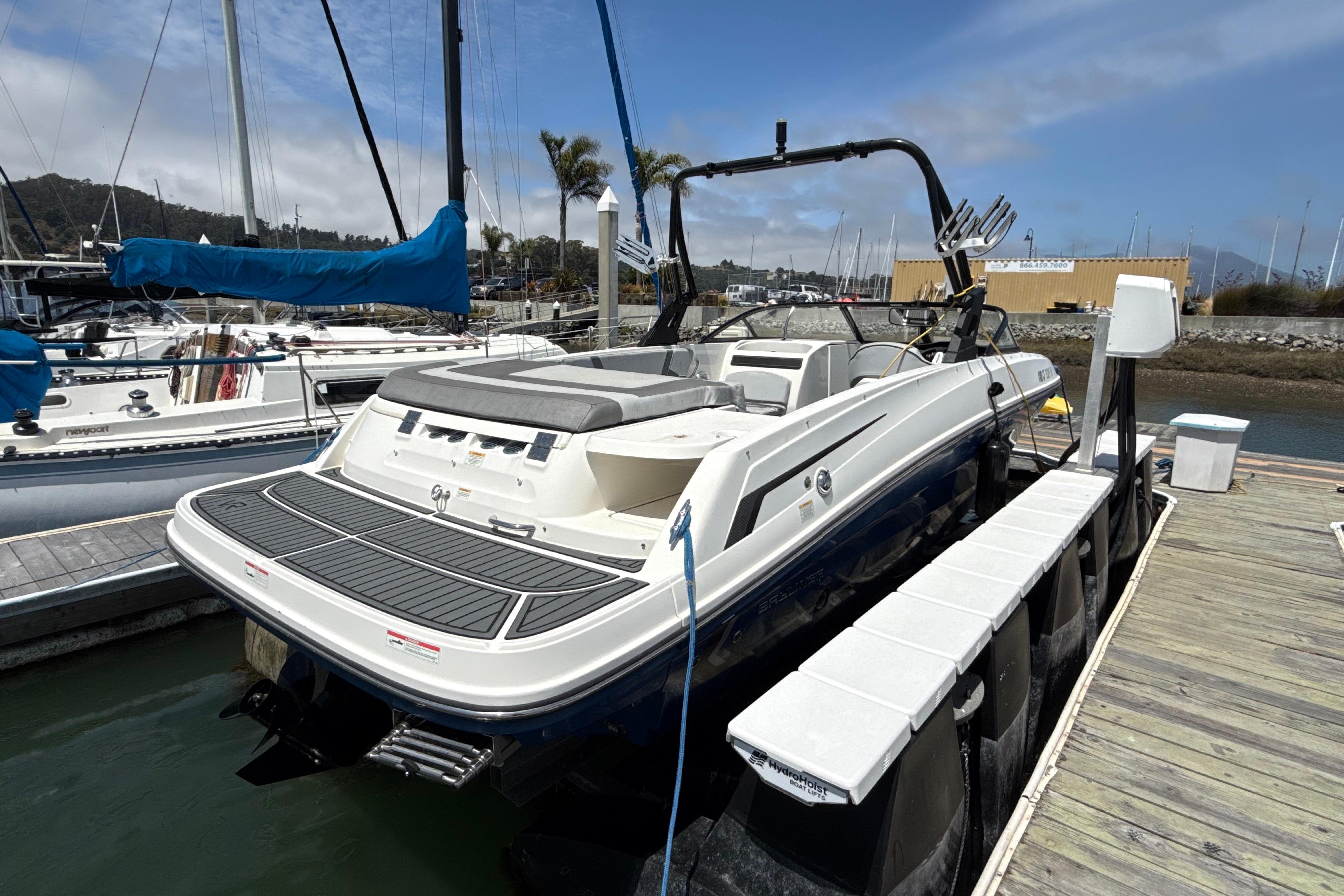 2021 Bayliner VR5 Bowrider I/O docked at marina, rear view.