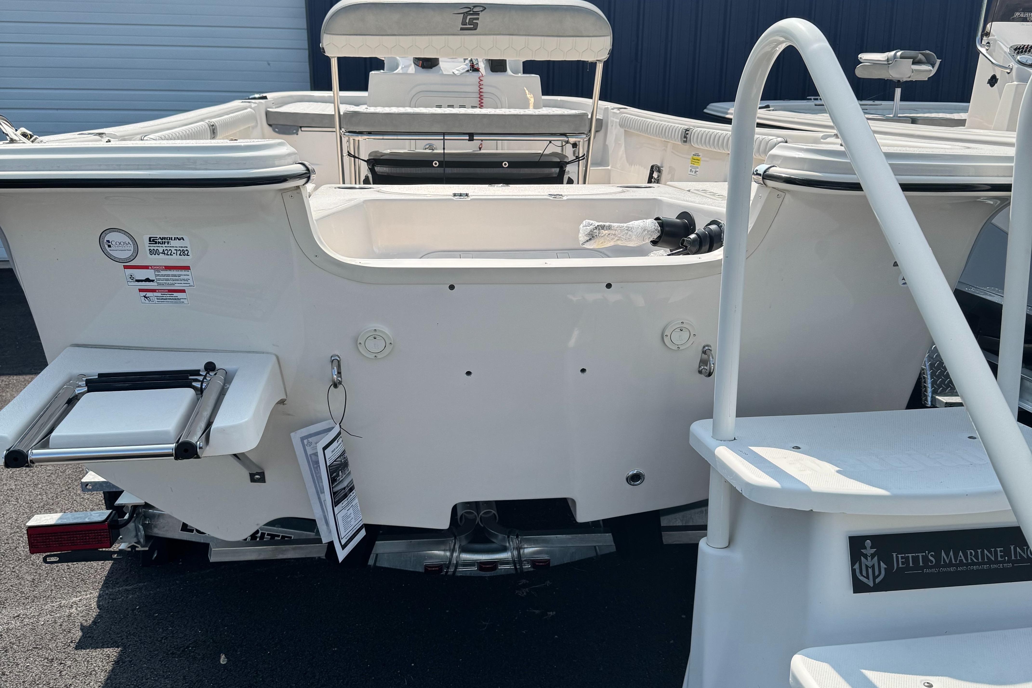 2025 Carolina Skiff 19 LS boat, rear view, white exterior, docked at marina.
