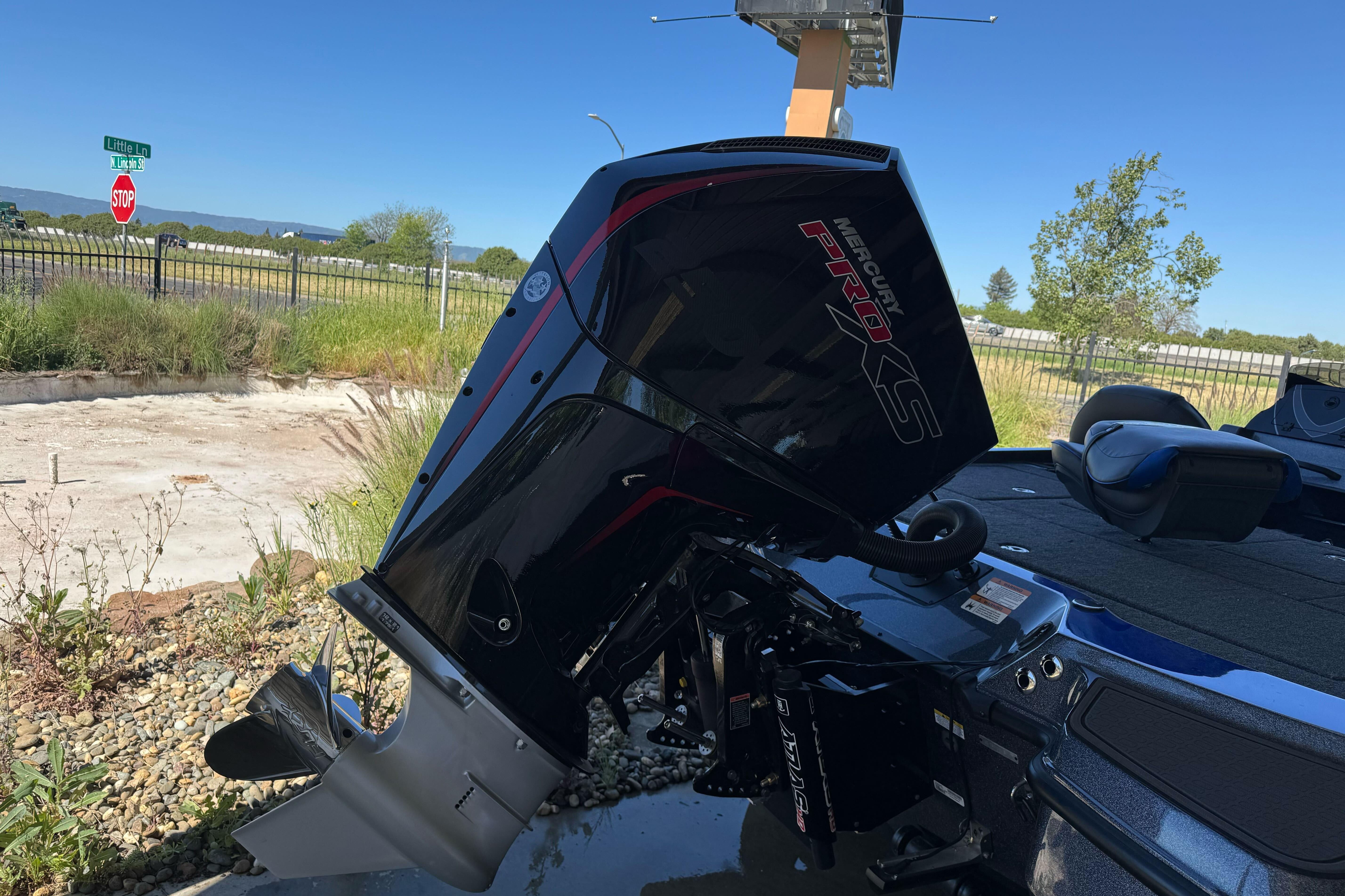 2026 Triton 21XP Patriot boat with Mercury Pro XS engine, parked outdoors.