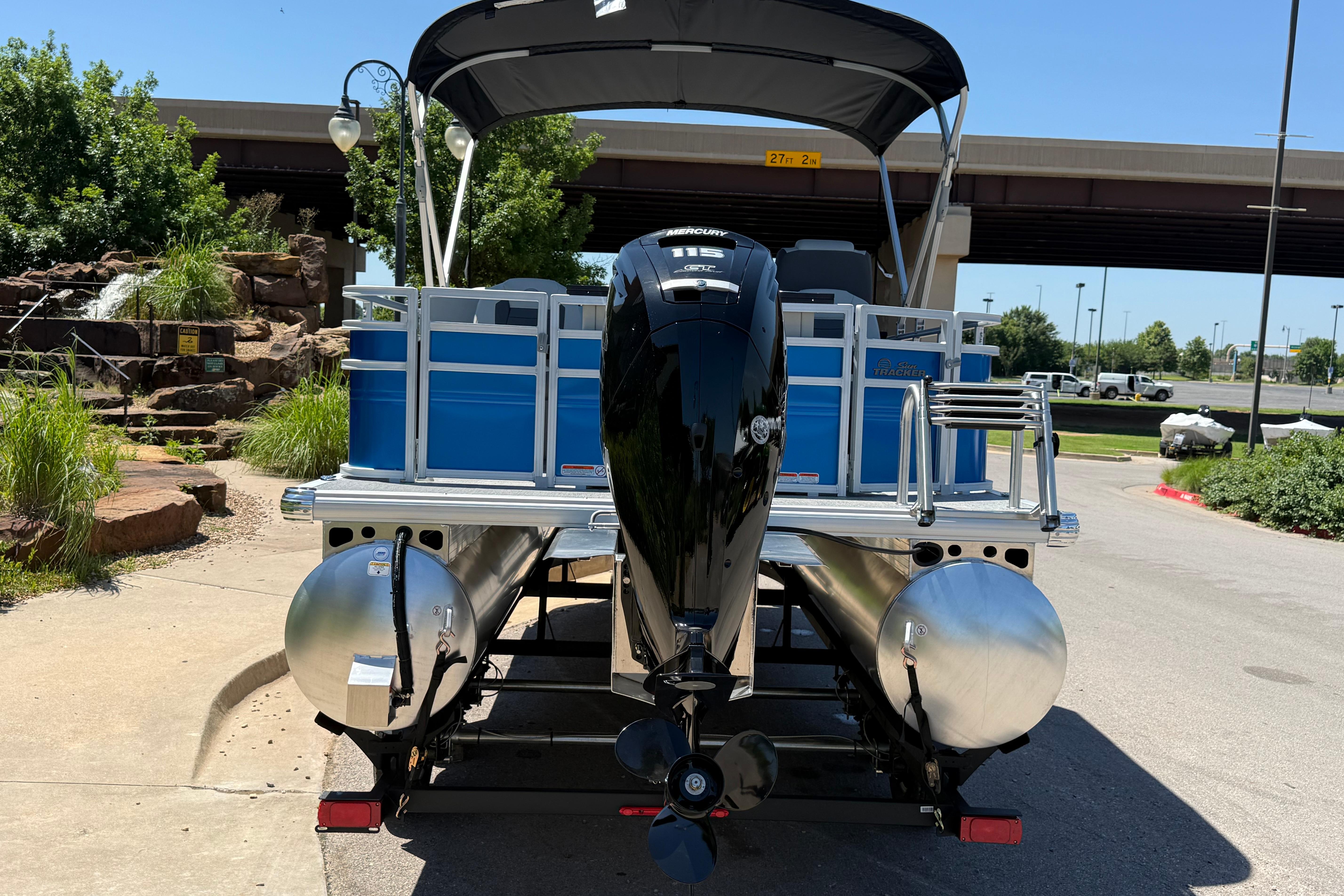 2026 Sun Tracker Fishin' Barge 20 DLX pontoon boat with Mercury outboard motor.