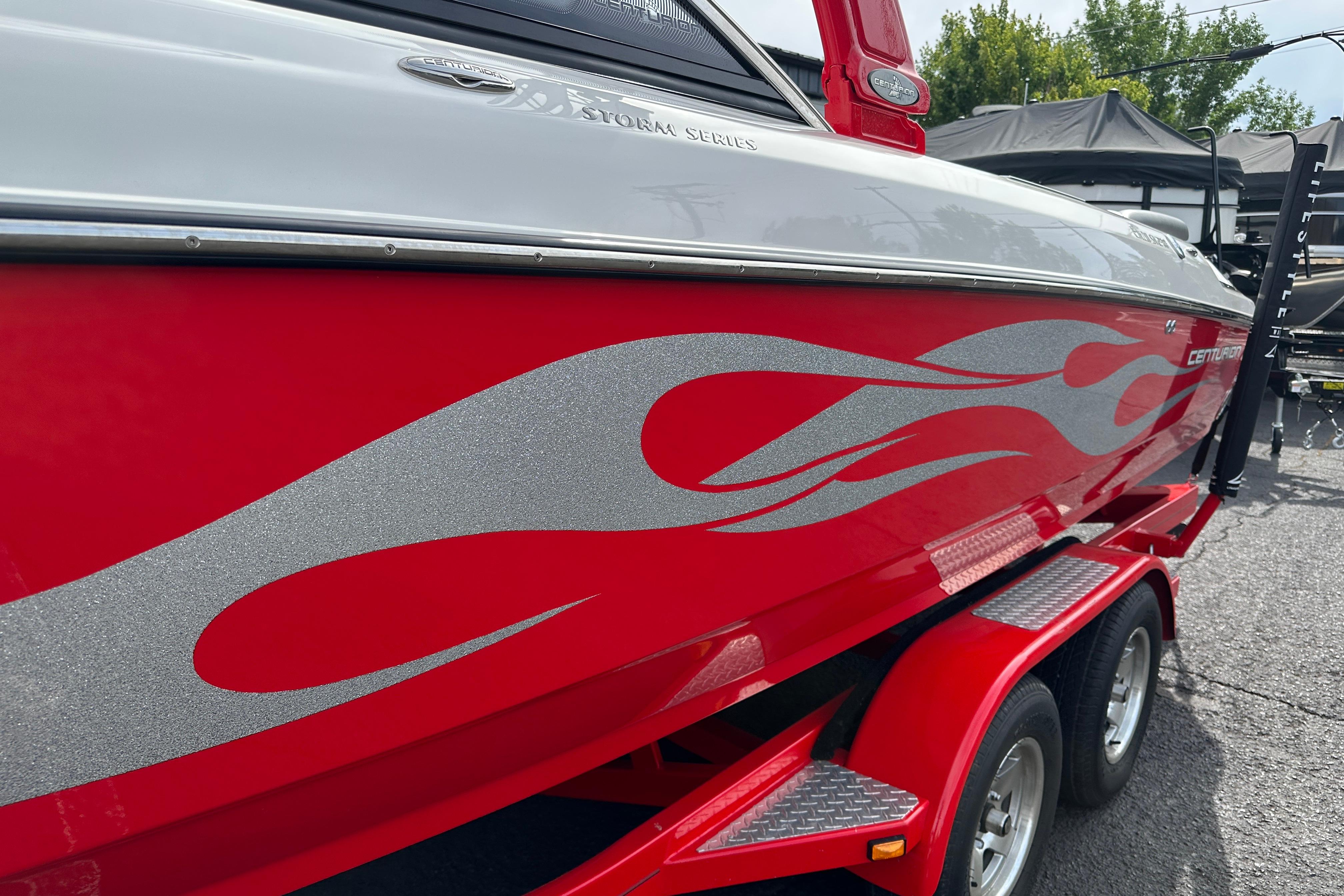 2008 Centurion Enzo SV240 boat with red flame design on trailer.