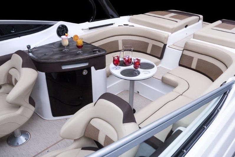 Interior of 2017 Rinker QX29 BR with luxurious seating and drinks.