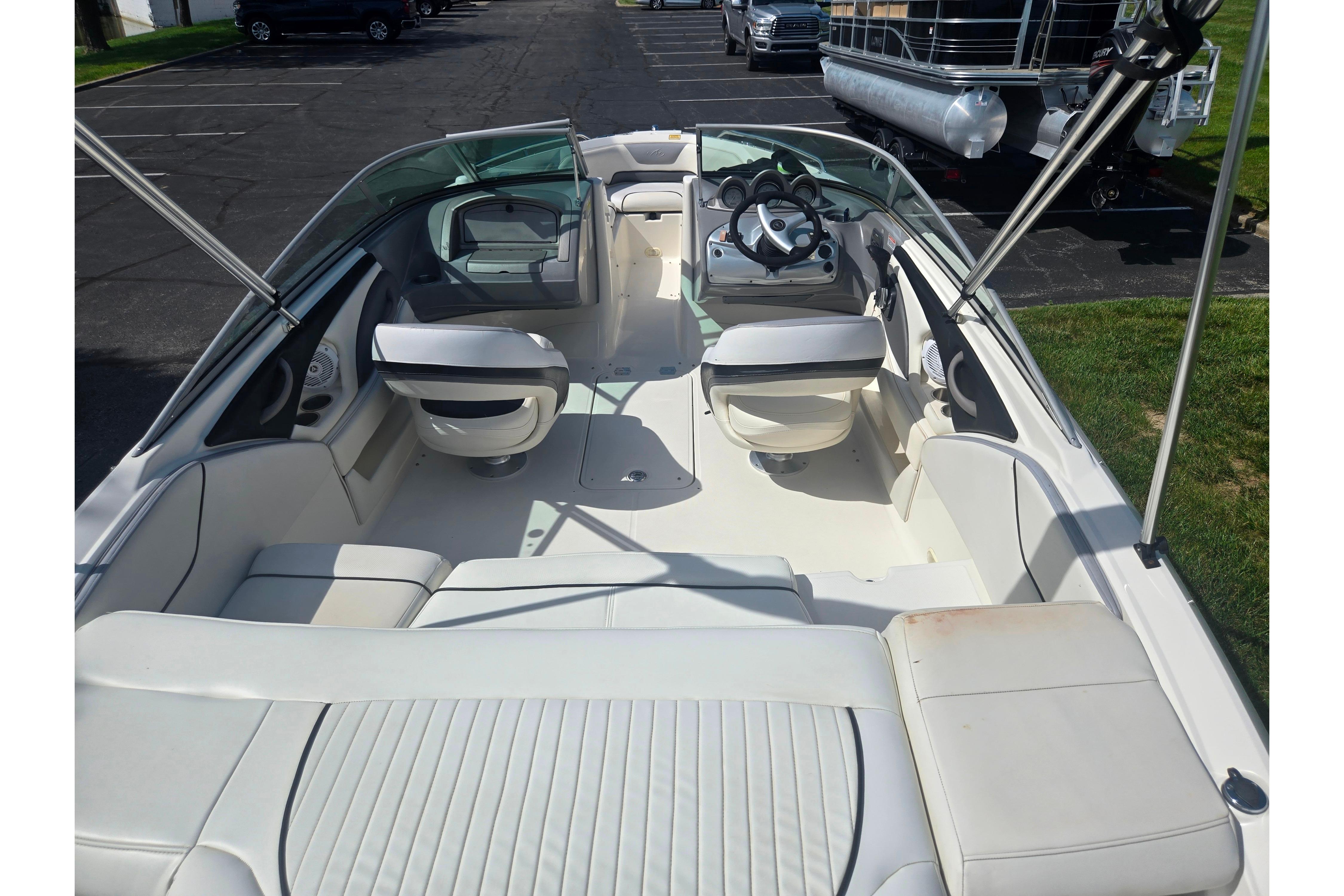 2006 Monterey 194FS Montura boat interior with white seating and steering wheel.