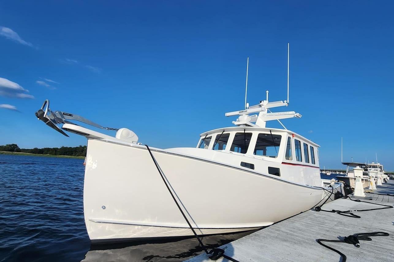 Northern Bay 36 Extended 38' Tuna rigged boat, docked, clear blue sky background.
