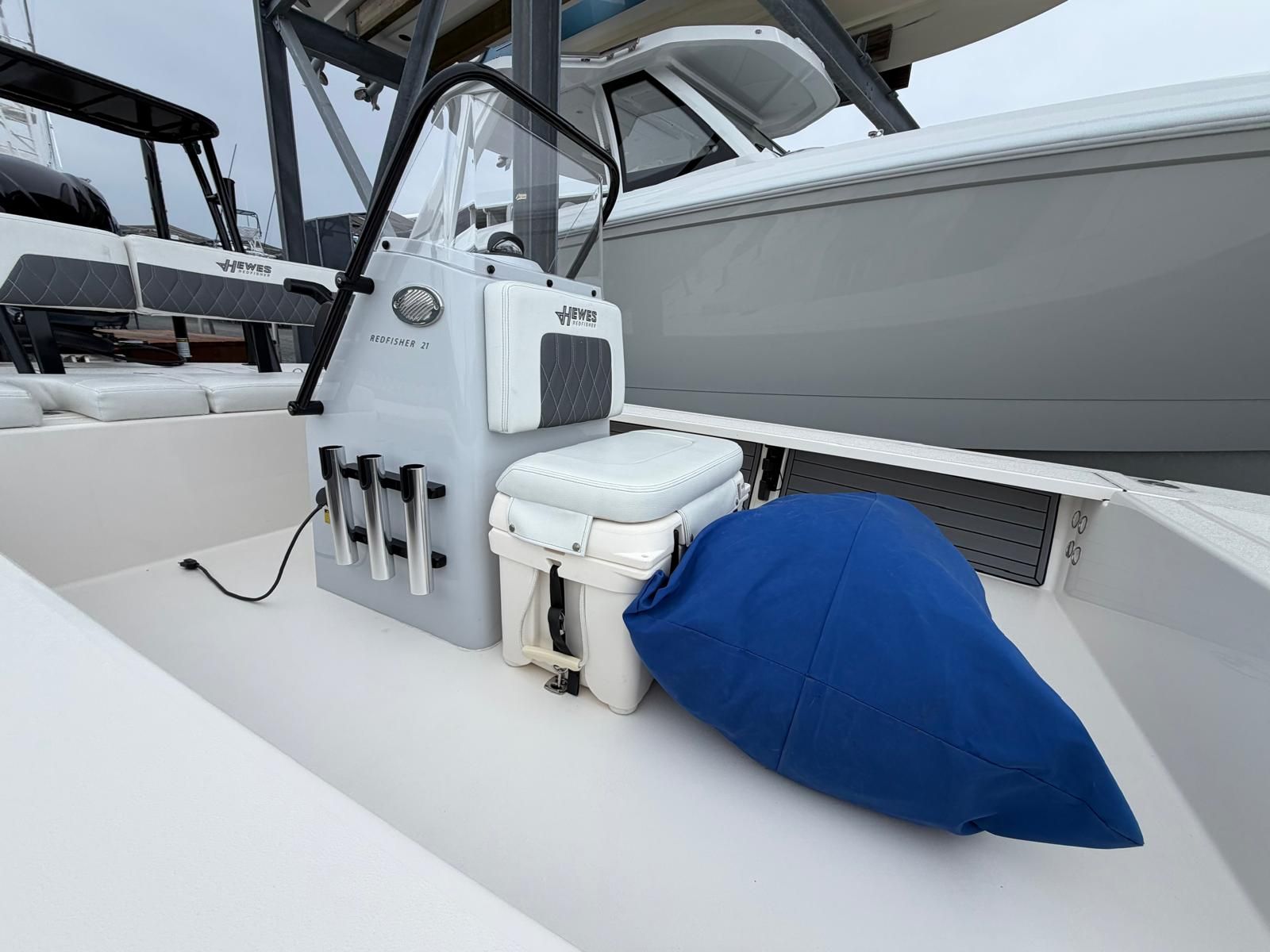 A 2022 Hewes Redfisher 21 with a white seat and blue cushion on the deck.