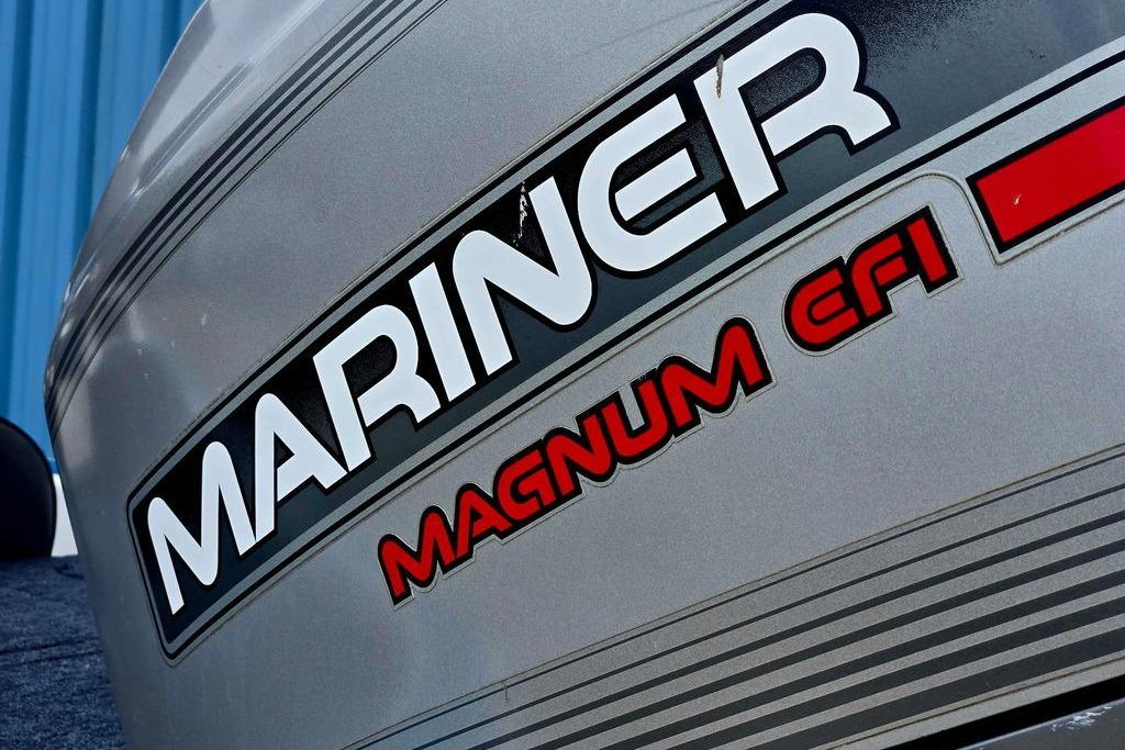 Close-up of Mariner Magnum EFI logo on a 1996 Champion 181 SX boat.