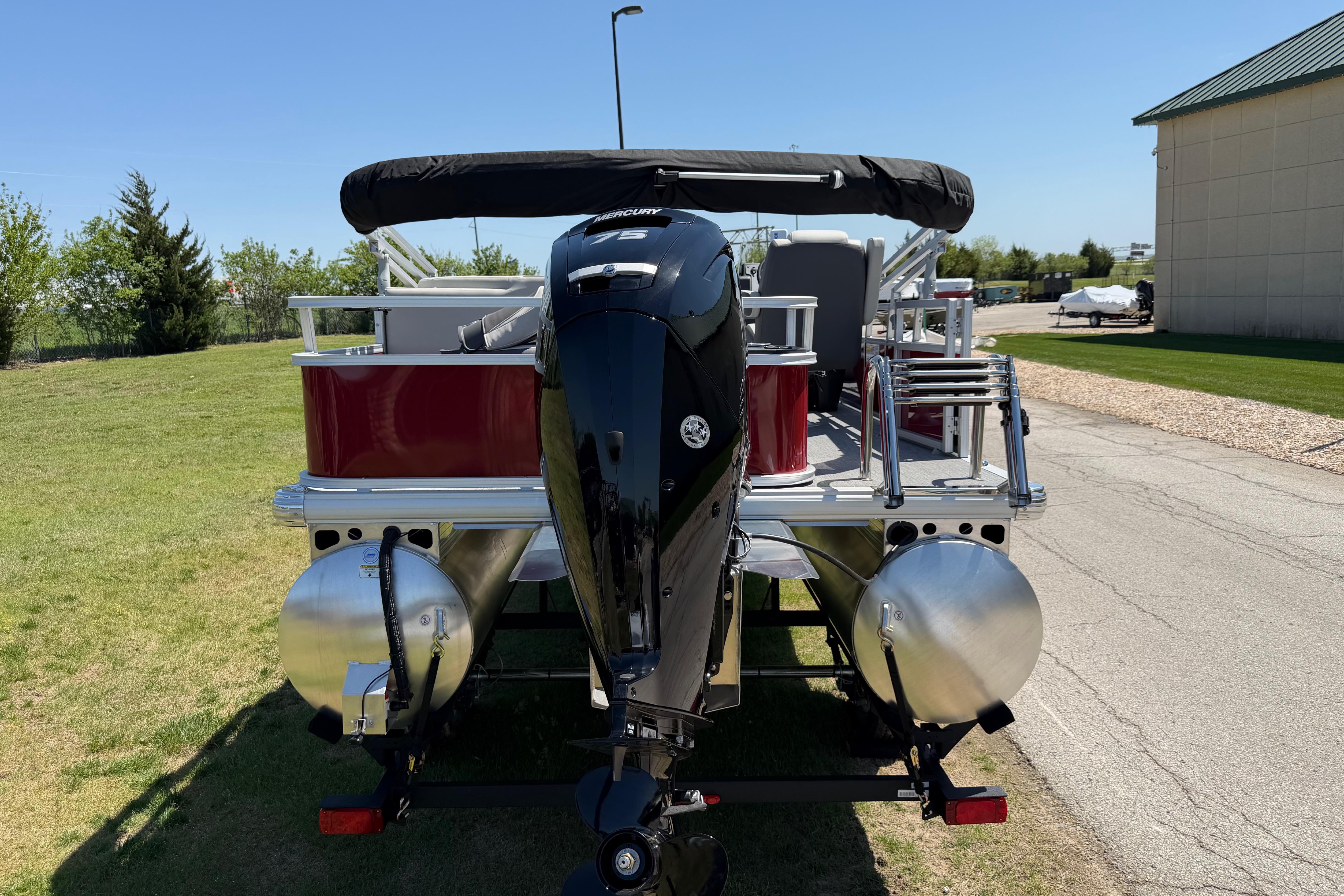 2026 Sun Tracker Bass Buggy 18 DLX pontoon boat with Mercury outboard motor.