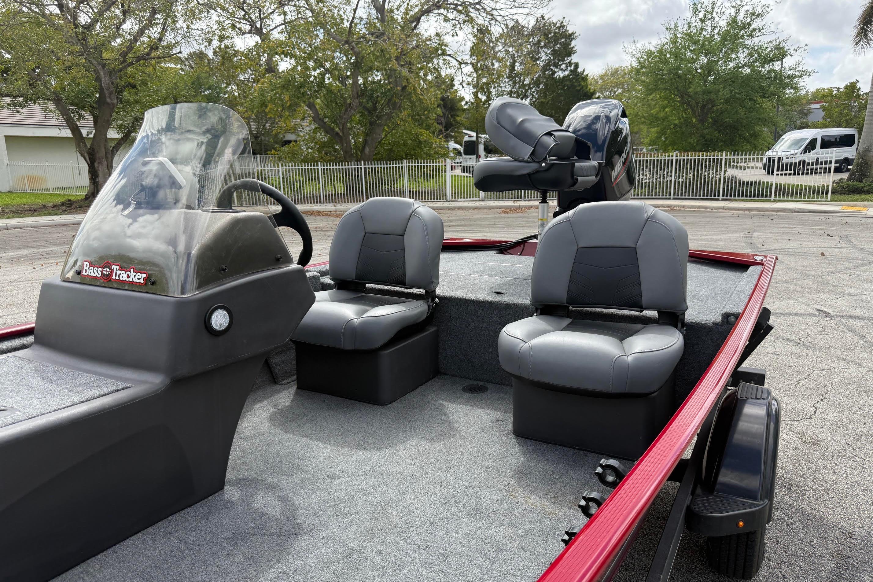 2023 Bass Tracker III Classic boat with seating and steering console, parked outdoors.