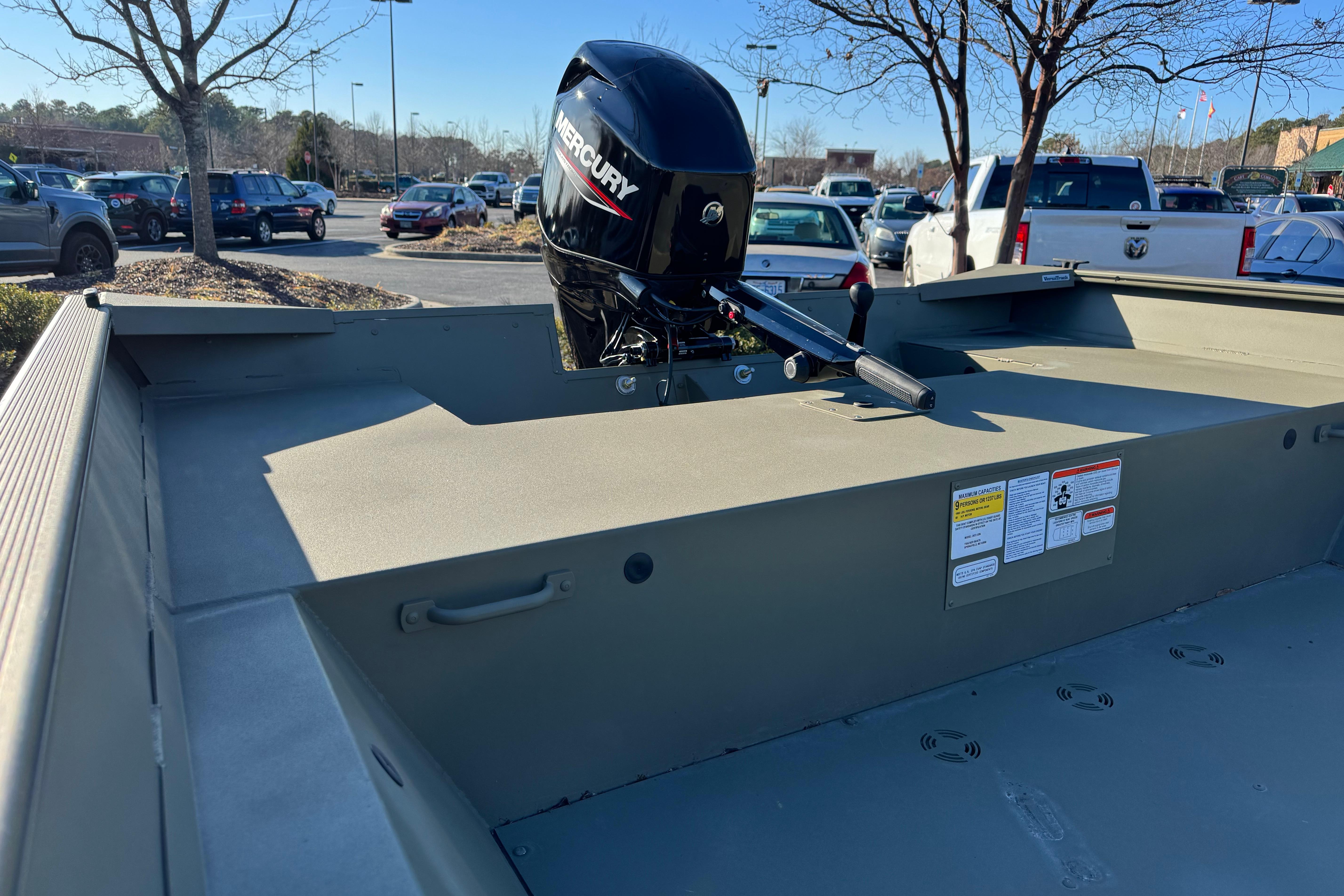 2026 Tracker Grizzly 2072 Utility boat with Mercury outboard motor in parking lot.