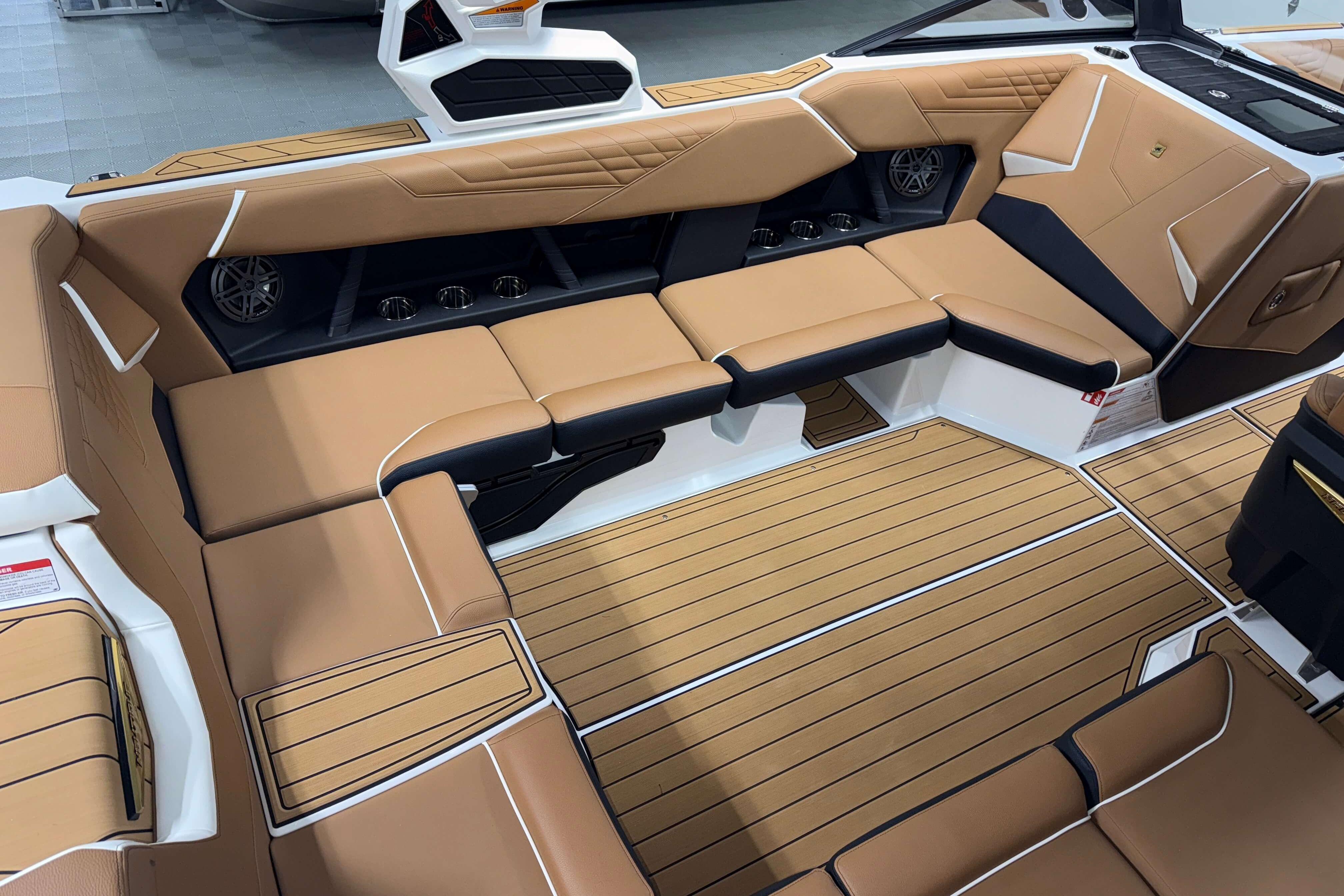 Luxurious interior of 2026 Nautique Super Air Nautique S23 boat with tan seating.