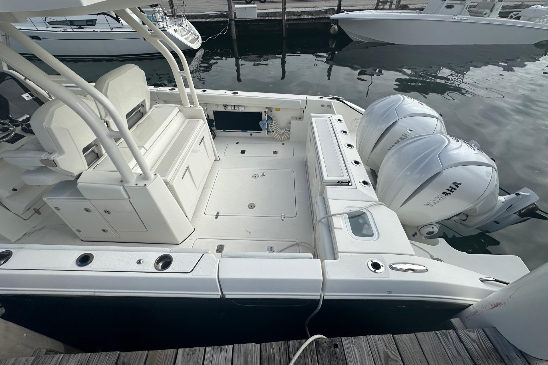 2023 Pursuit S 328 Sport boat with dual Yamaha engines docked at marina.