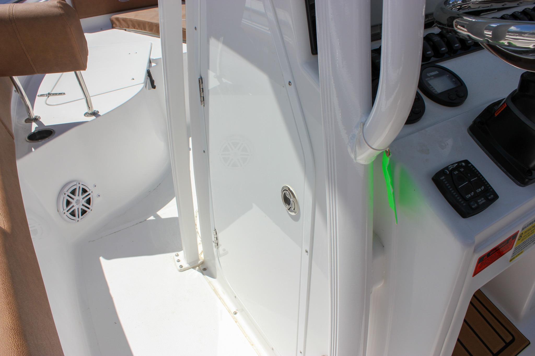 Interior view of a 2027 Sea Hunt Ultra 234 boat, showcasing controls and seating area.