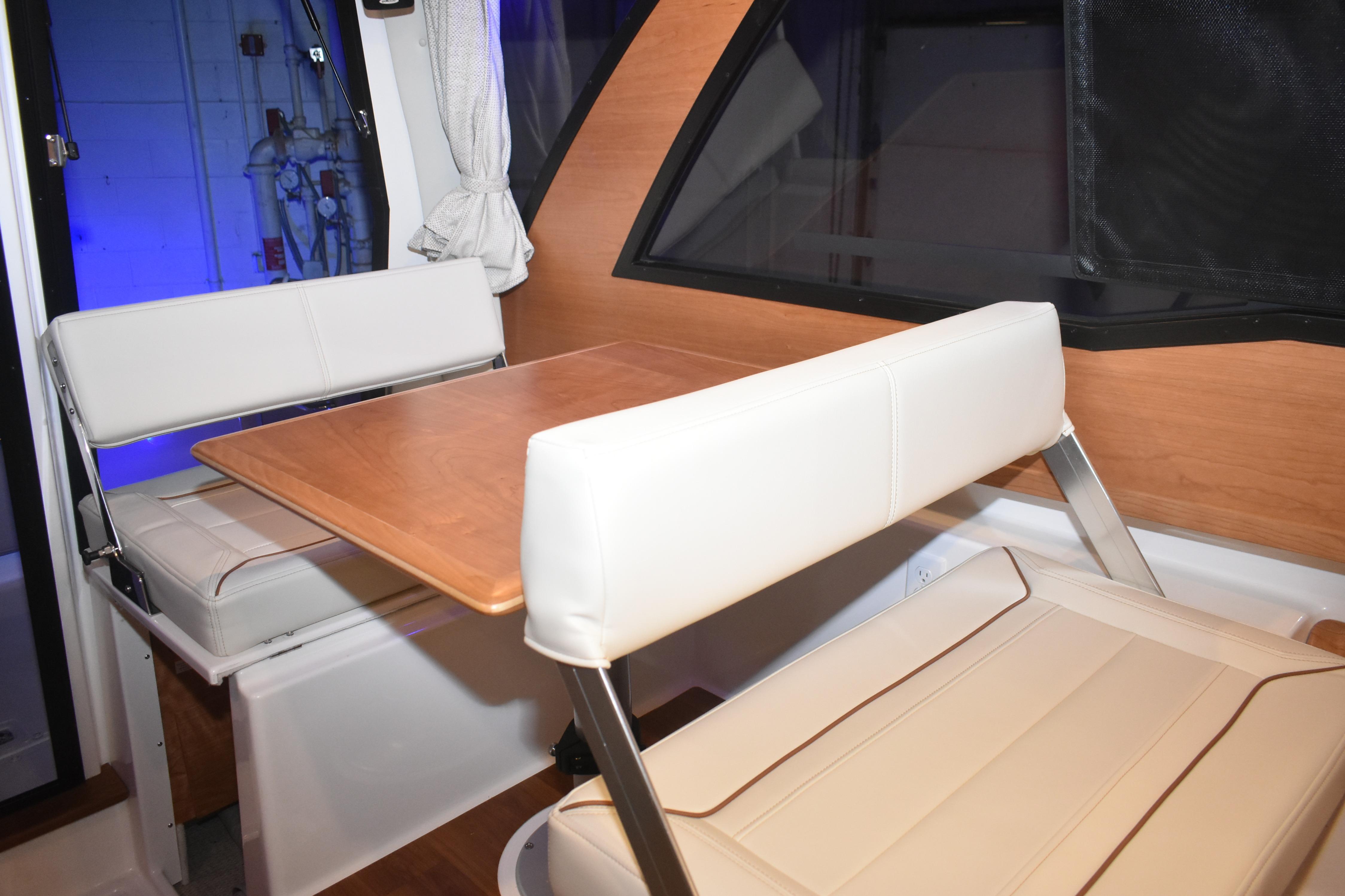 Interior of 2026 Cutwater C-248 Coupe featuring a cozy dining area with white seating.