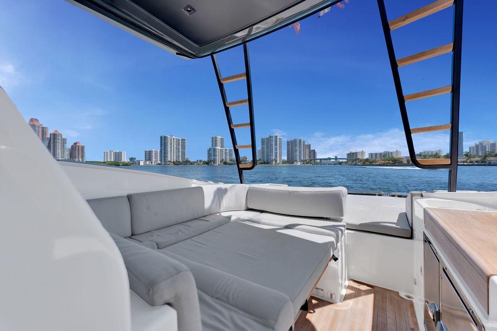 Luxurious 2021 Bluegame BG 42 yacht interior with waterfront city skyline view.