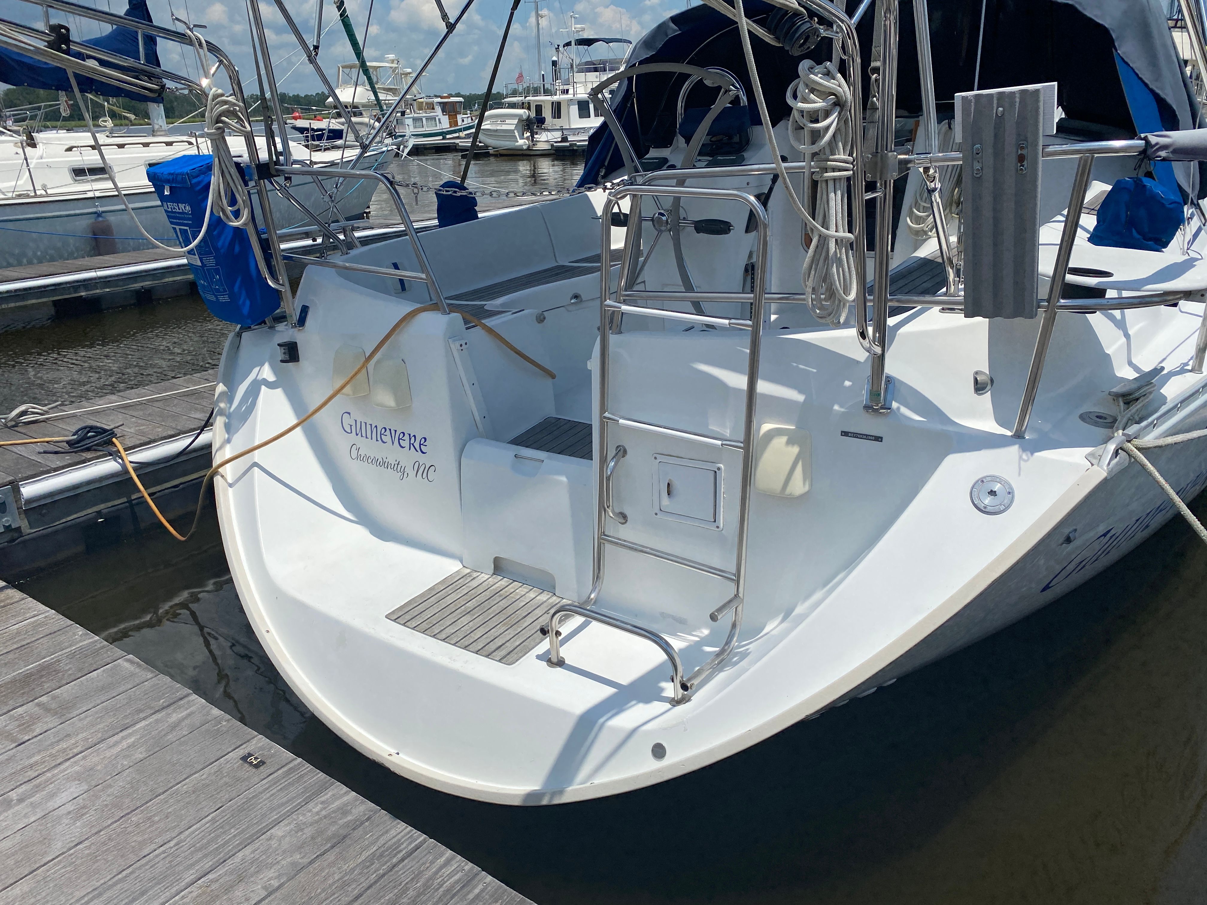 The image shows the stern of a 2000 Beneteau Oceanis 361 docked at a marina.