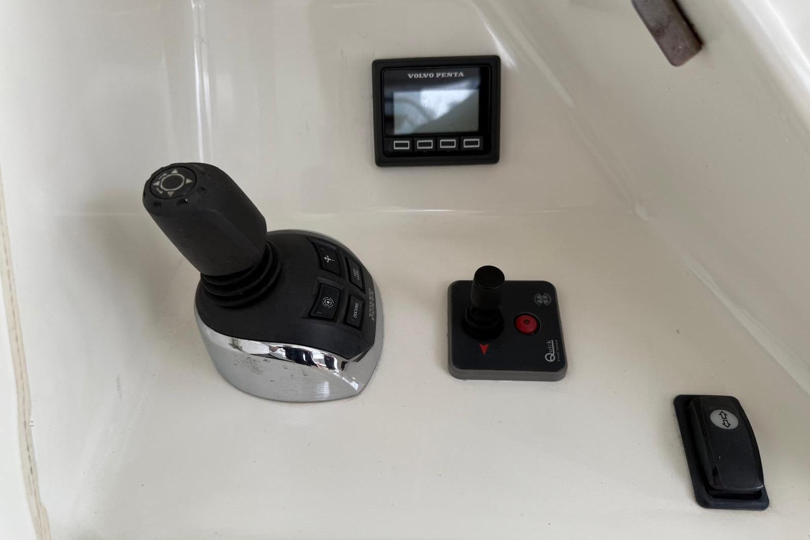 Control panel of a 2019 Prestige 630 yacht with joystick and display.