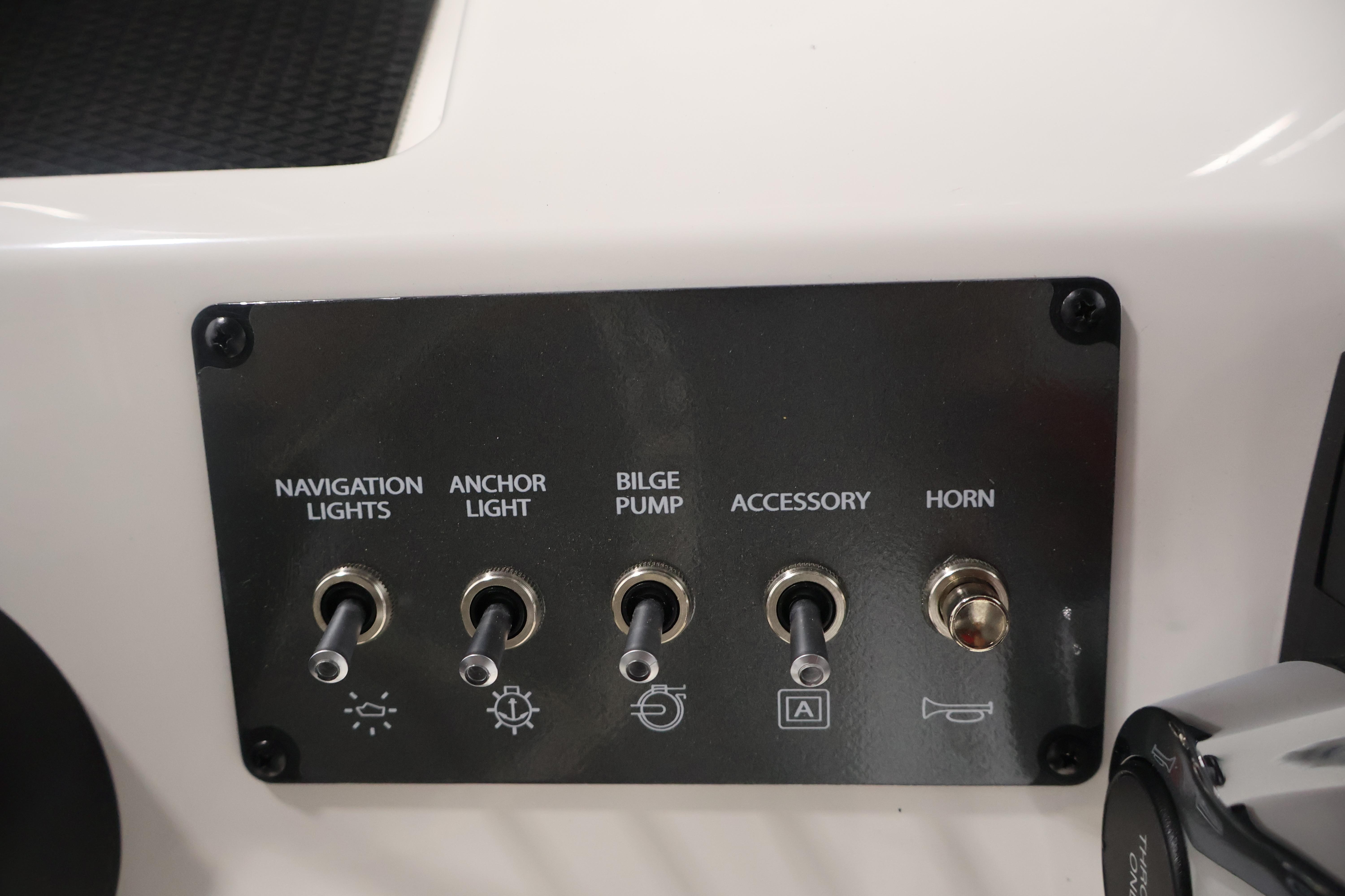 Control panel of 2026 Bayliner Trophy T18 boat with switches for lights, pump, and horn.