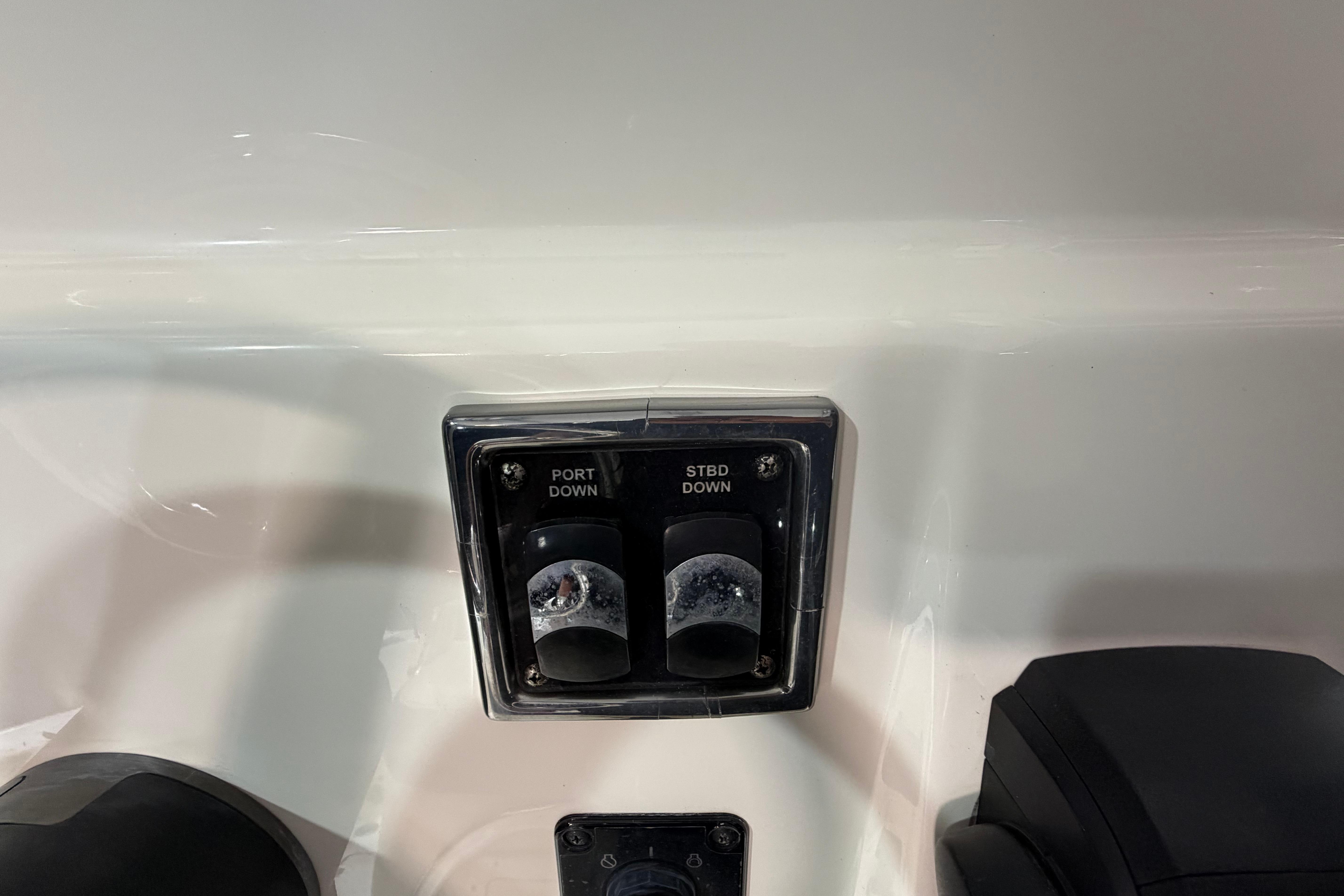 2023 Cobia 237 Center Console boat controls with port and starboard switches.