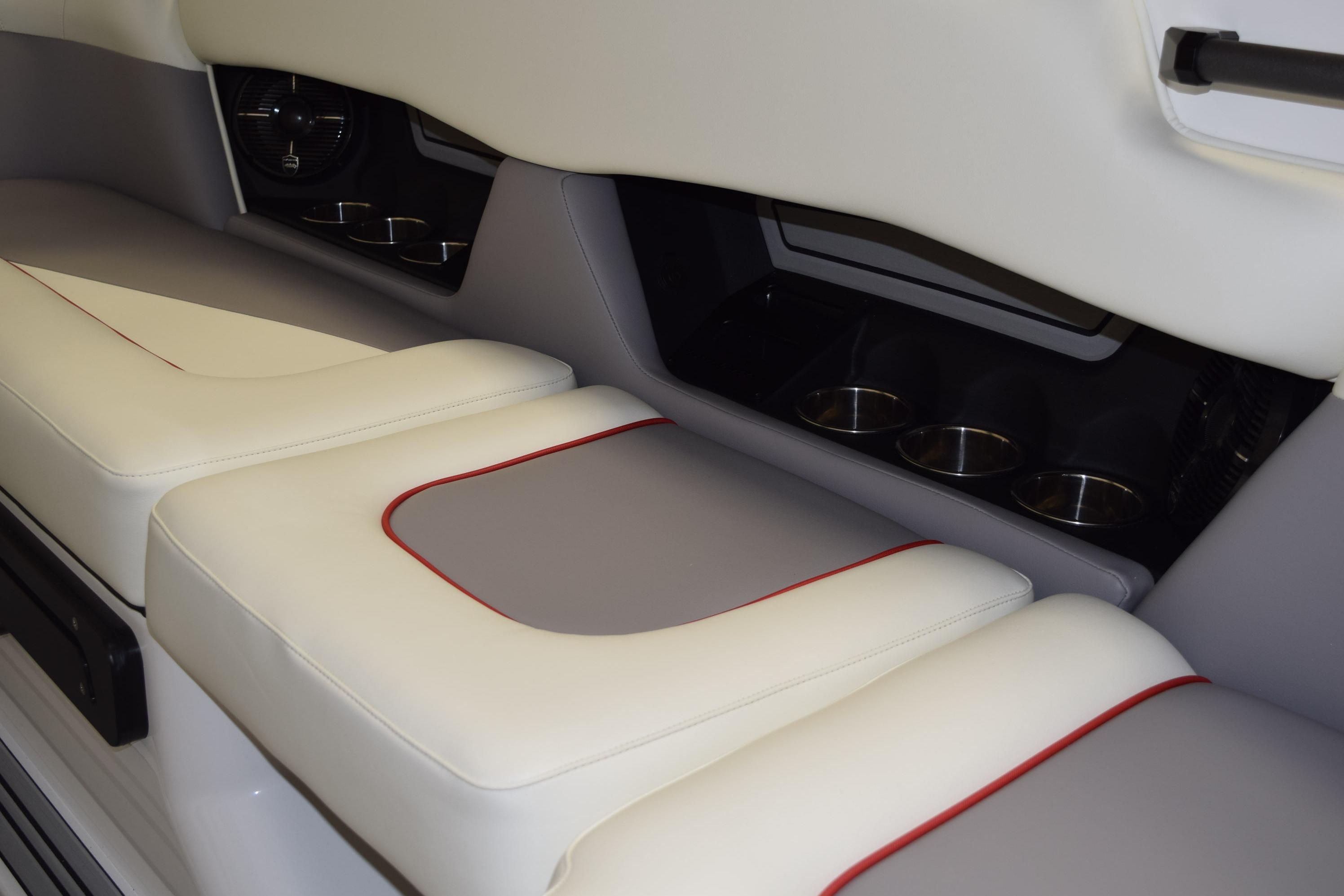2026 Moomba Craz interior seating with cup holders, featuring white and gray upholstery.