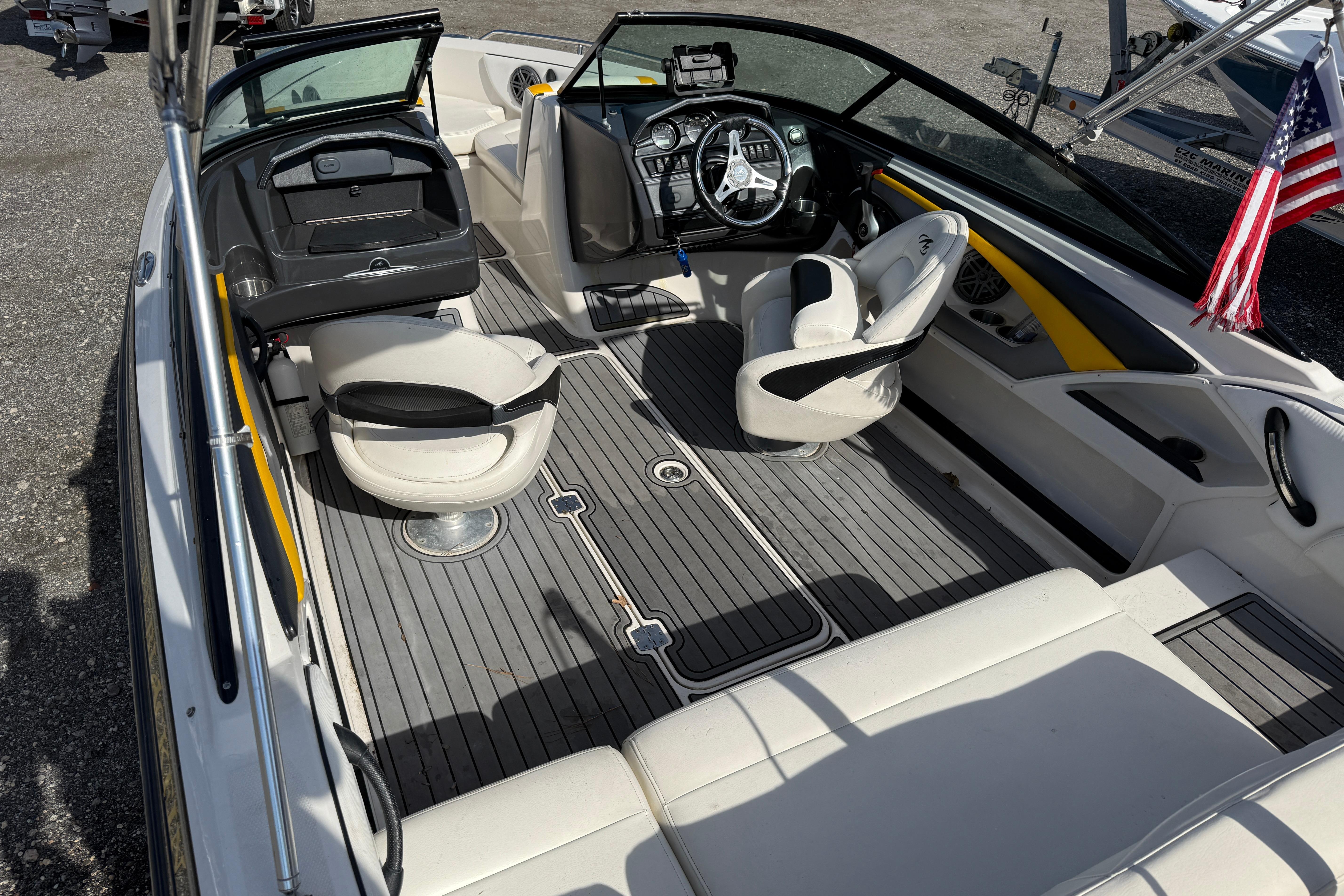 2014 Monterey 197 Blackfin boat interior with seating and steering wheel, featuring American flag.
