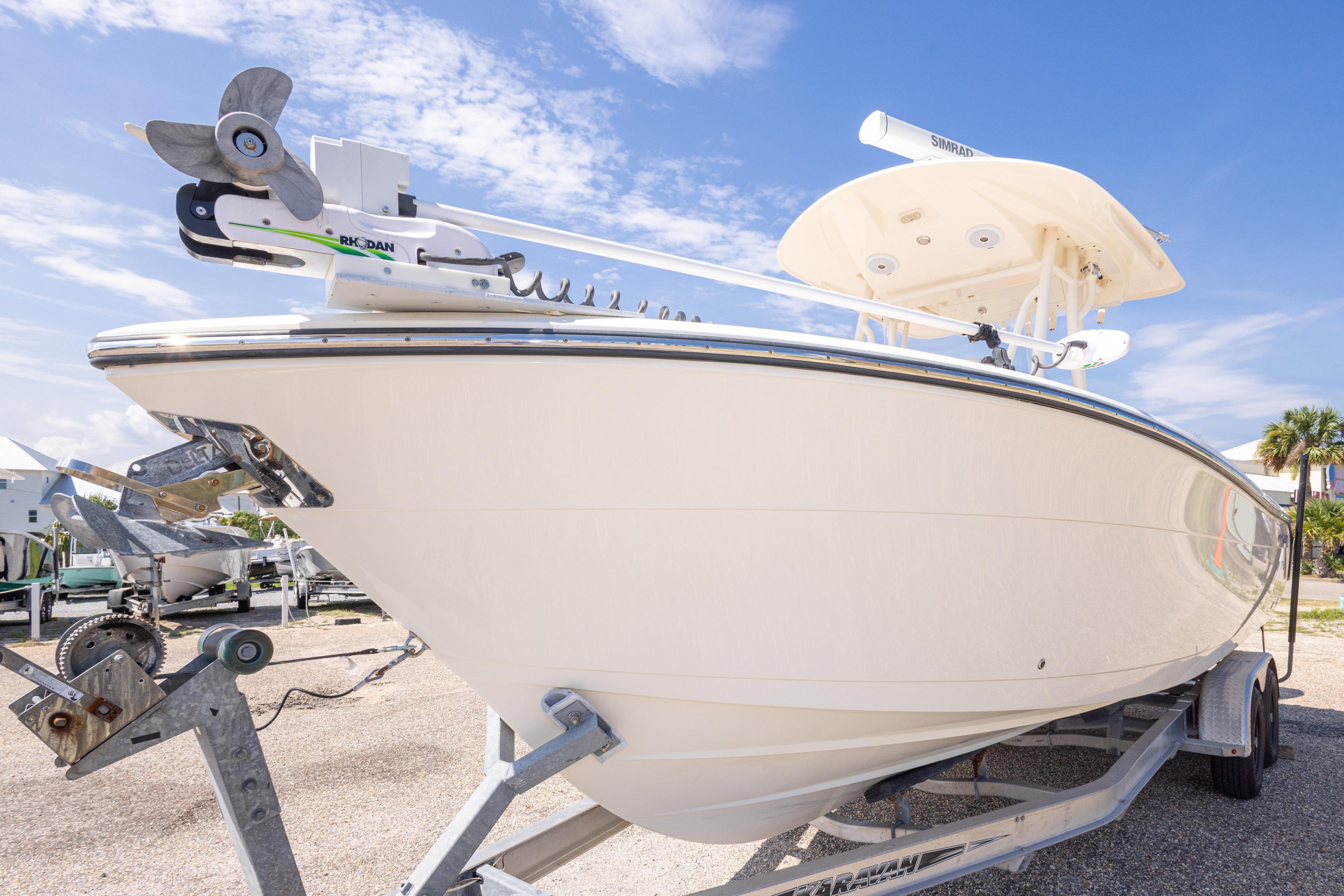 2017 Cobia 261 Center Console boat on trailer under clear blue sky.