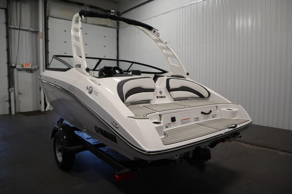 2026 Yamaha Boats 195S in a showroom, showcasing sleek design and modern features.