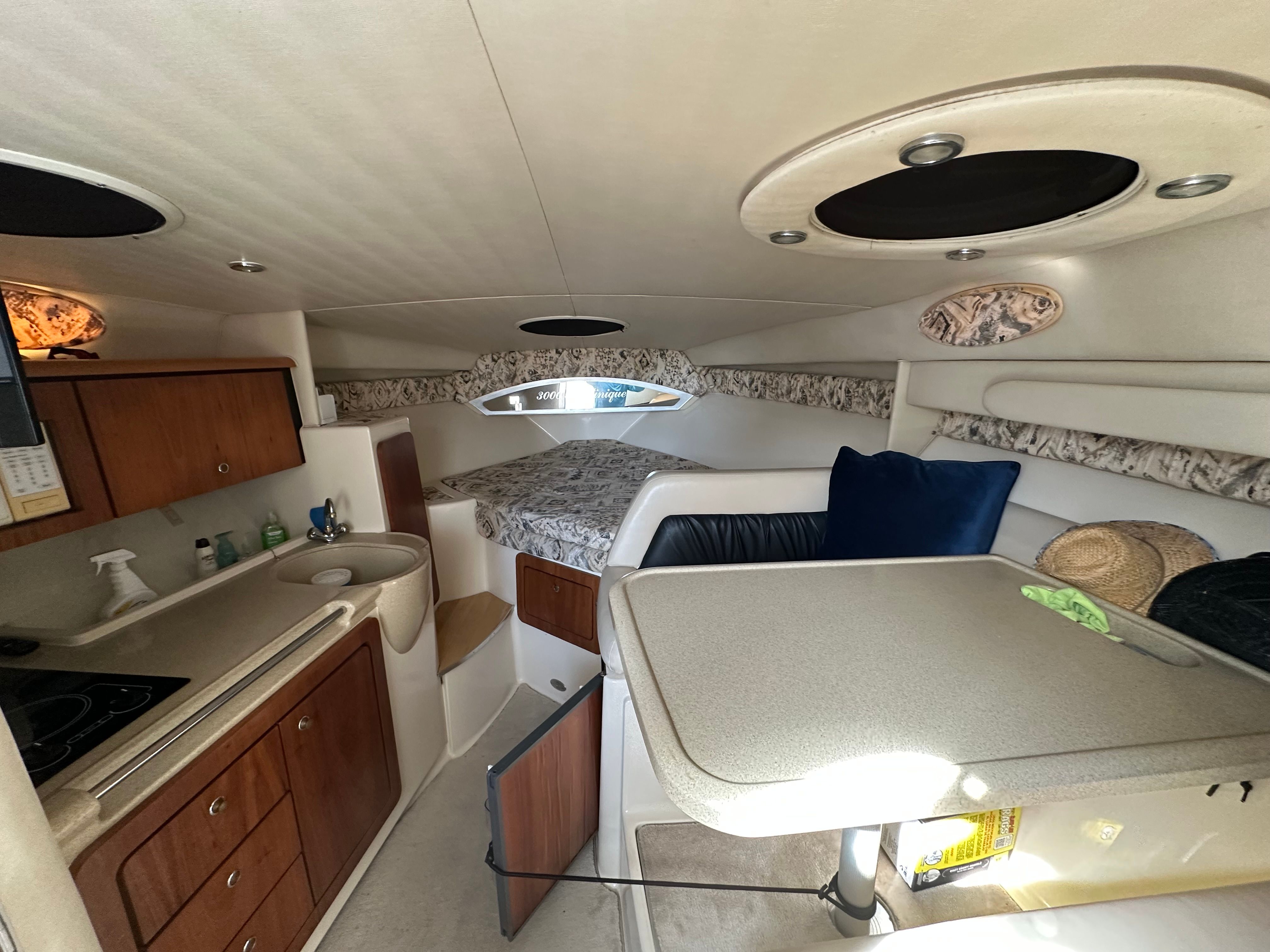 Interior of 1999 Wellcraft 3000 Martinique with kitchen and sleeping area.