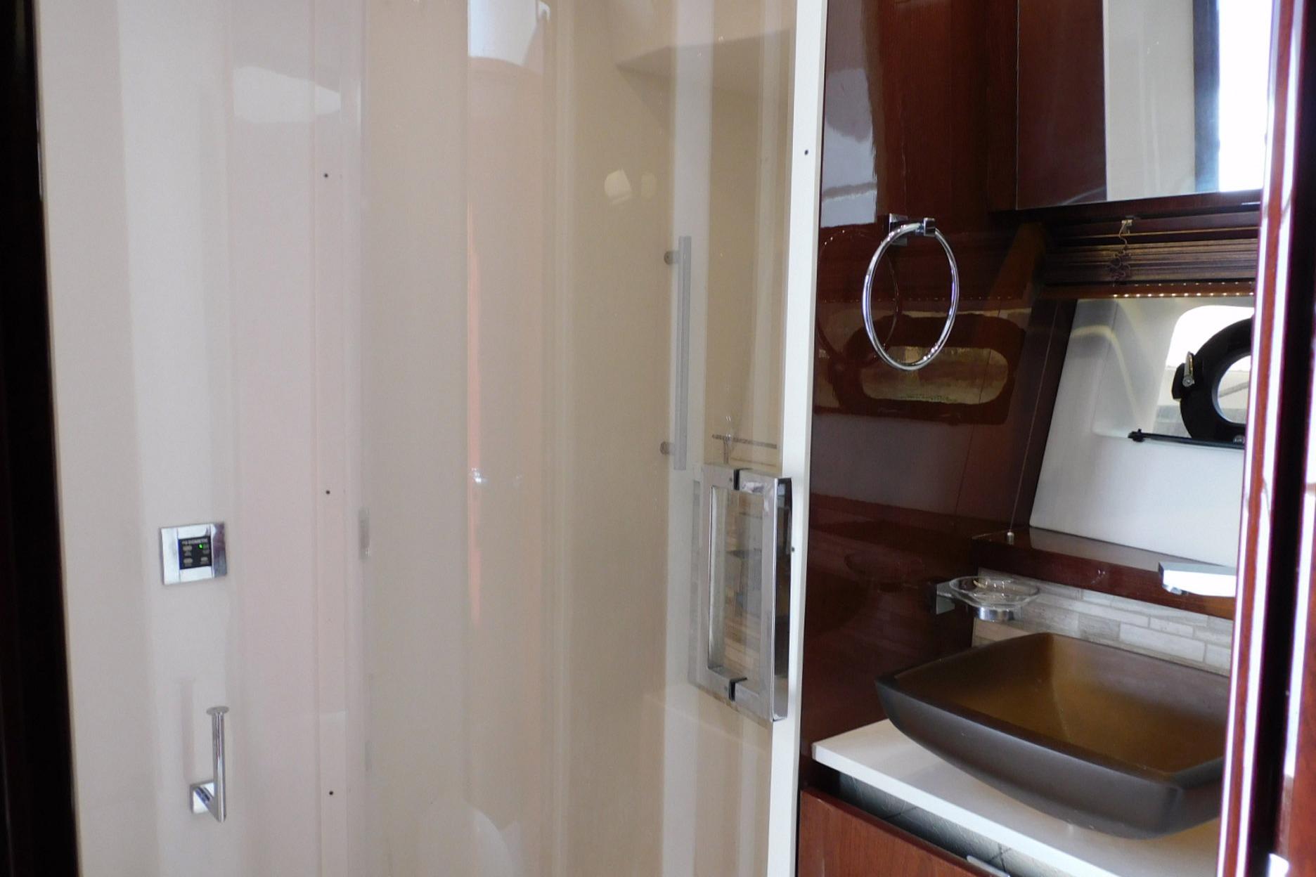 Luxurious bathroom interior of 2019 Sea Ray L550 yacht with modern fixtures and elegant design.