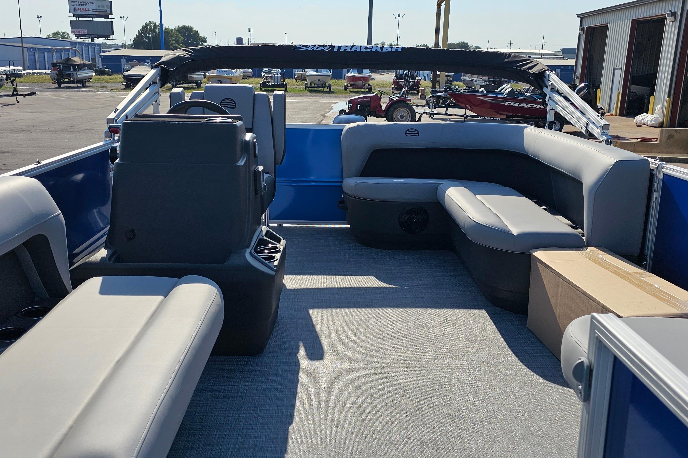 2026 Sun Tracker Party Barge 16 DLX interior with gray seating and open deck space.