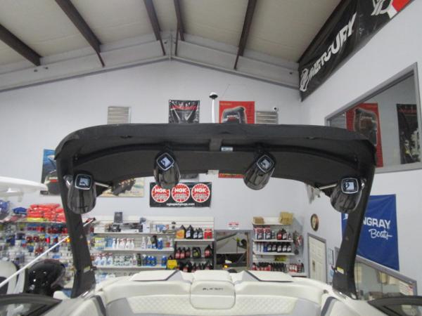 2017 Larson 292 LXI boat interior with speakers and accessories in a showroom.