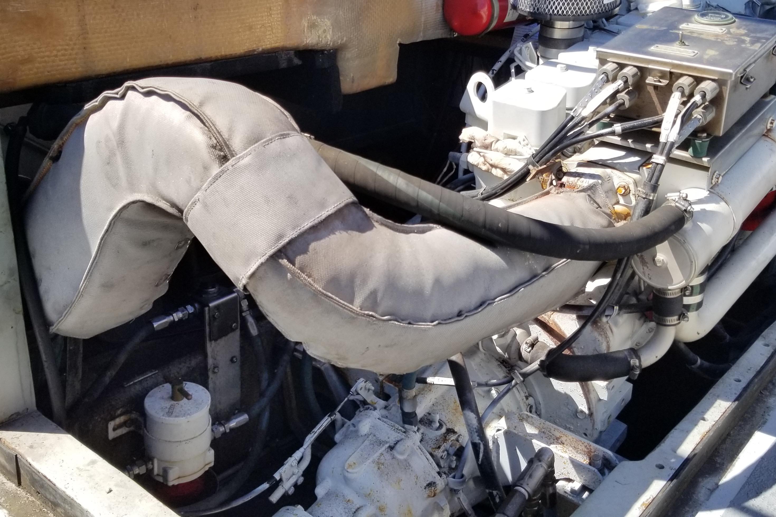 Engine compartment of a 1994 Willard US Navy vessel, featuring insulated exhaust components.