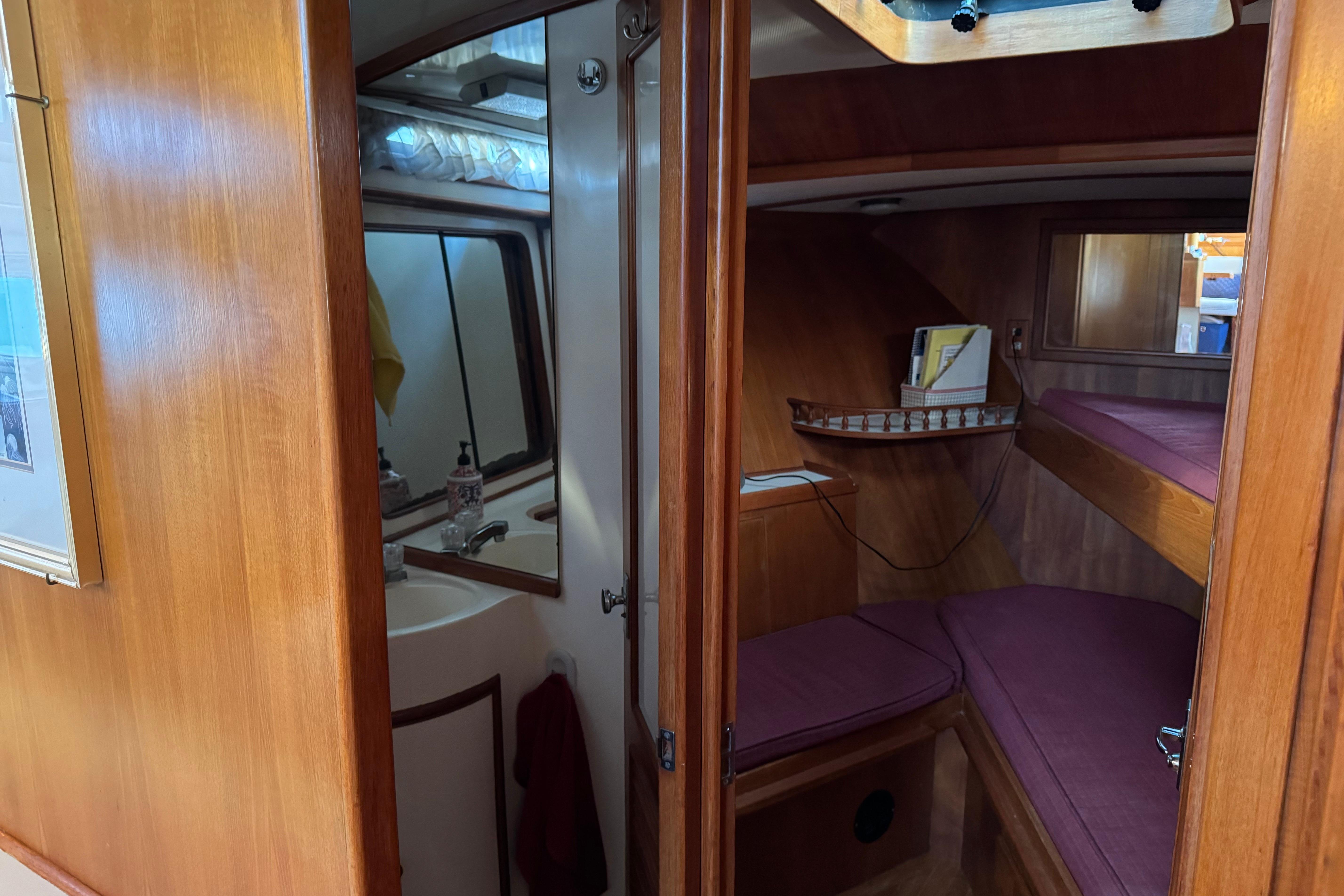 Interior of a 1987 President 37 yacht featuring a cozy cabin and bathroom.