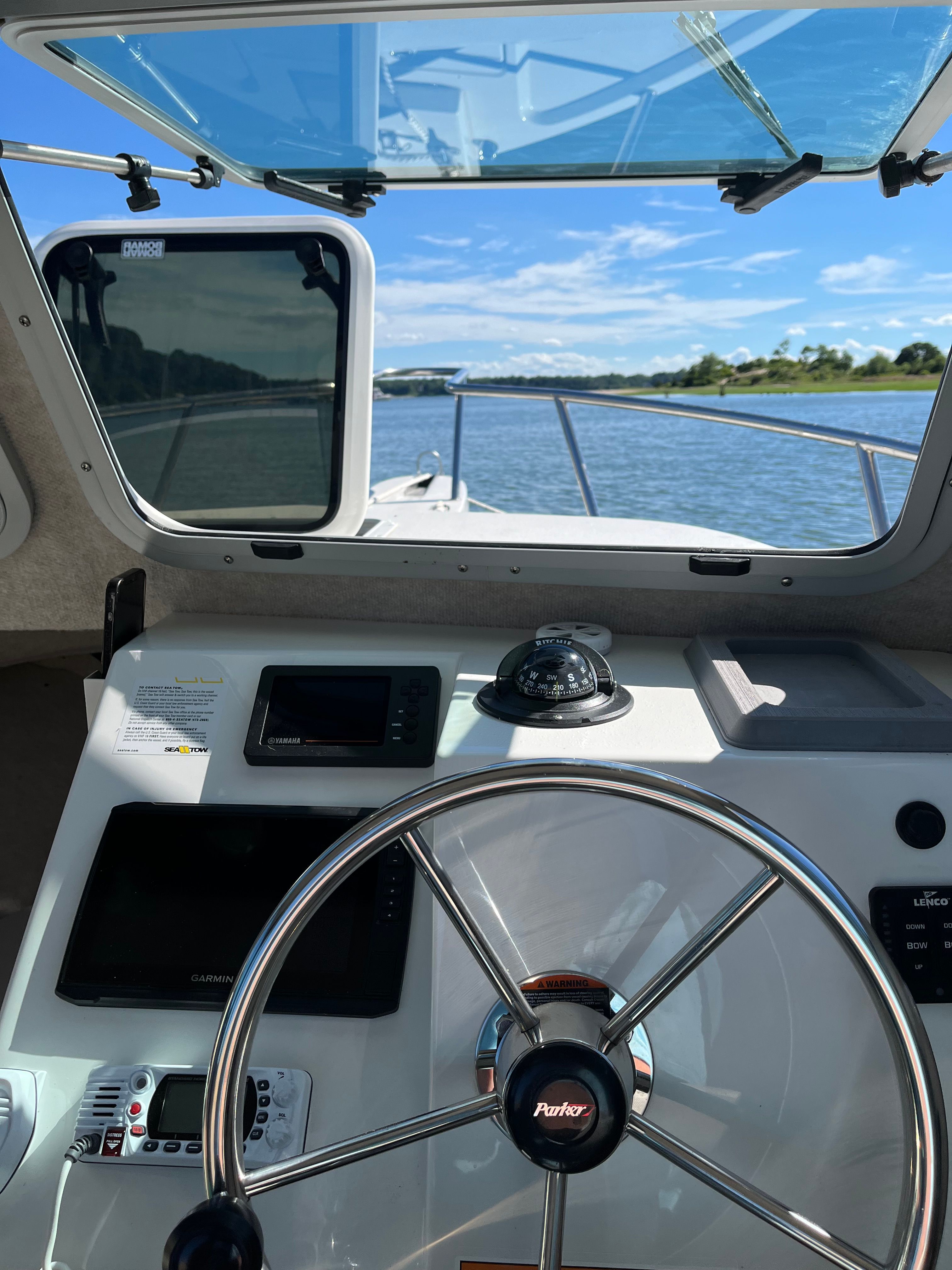 Helm of a Parker 2021 sport cabin with a view of the water.