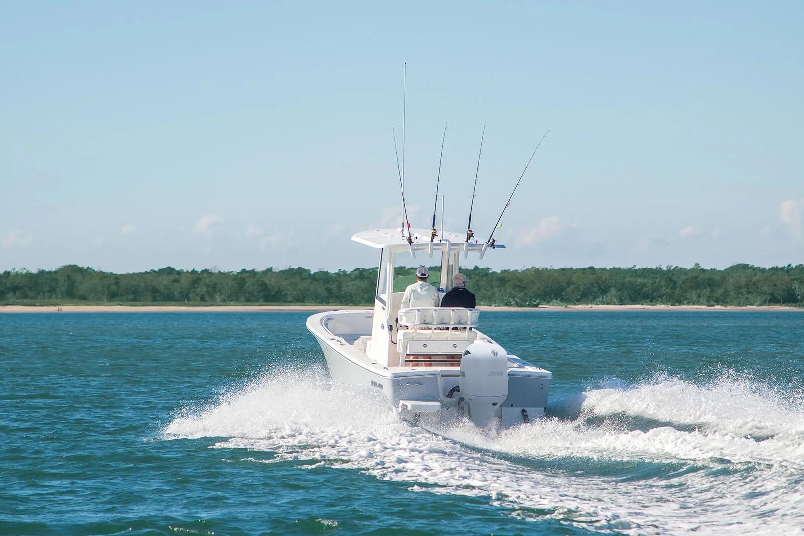 2027 Regulator 24XO boat cruising on open water with fishing rods.