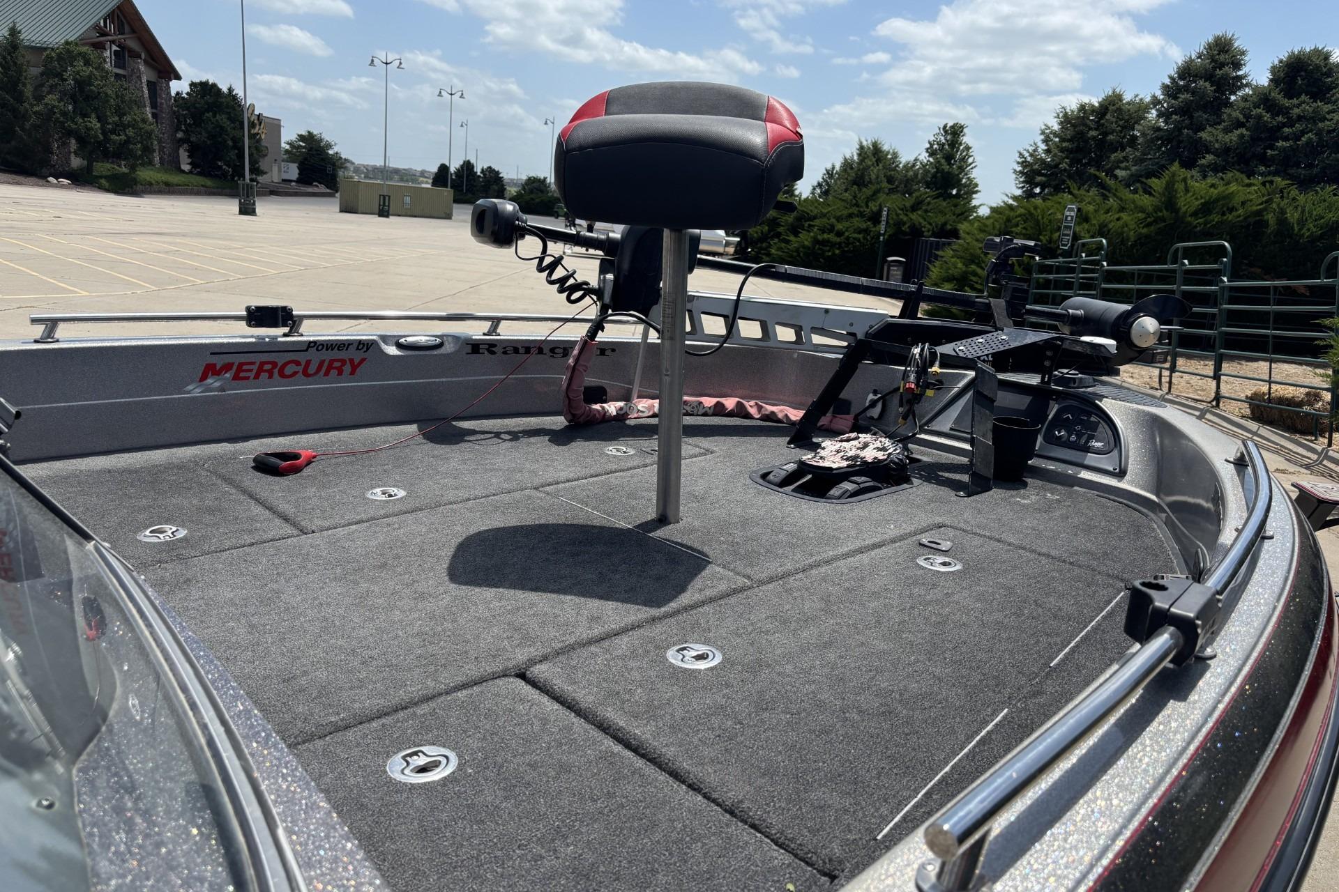 2011 Ranger 620 VS fishing boat deck with Mercury engine branding, parked outdoors.