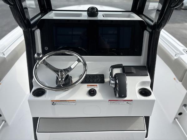 2025 Sportsman Open 232 boat console with steering wheel and controls.