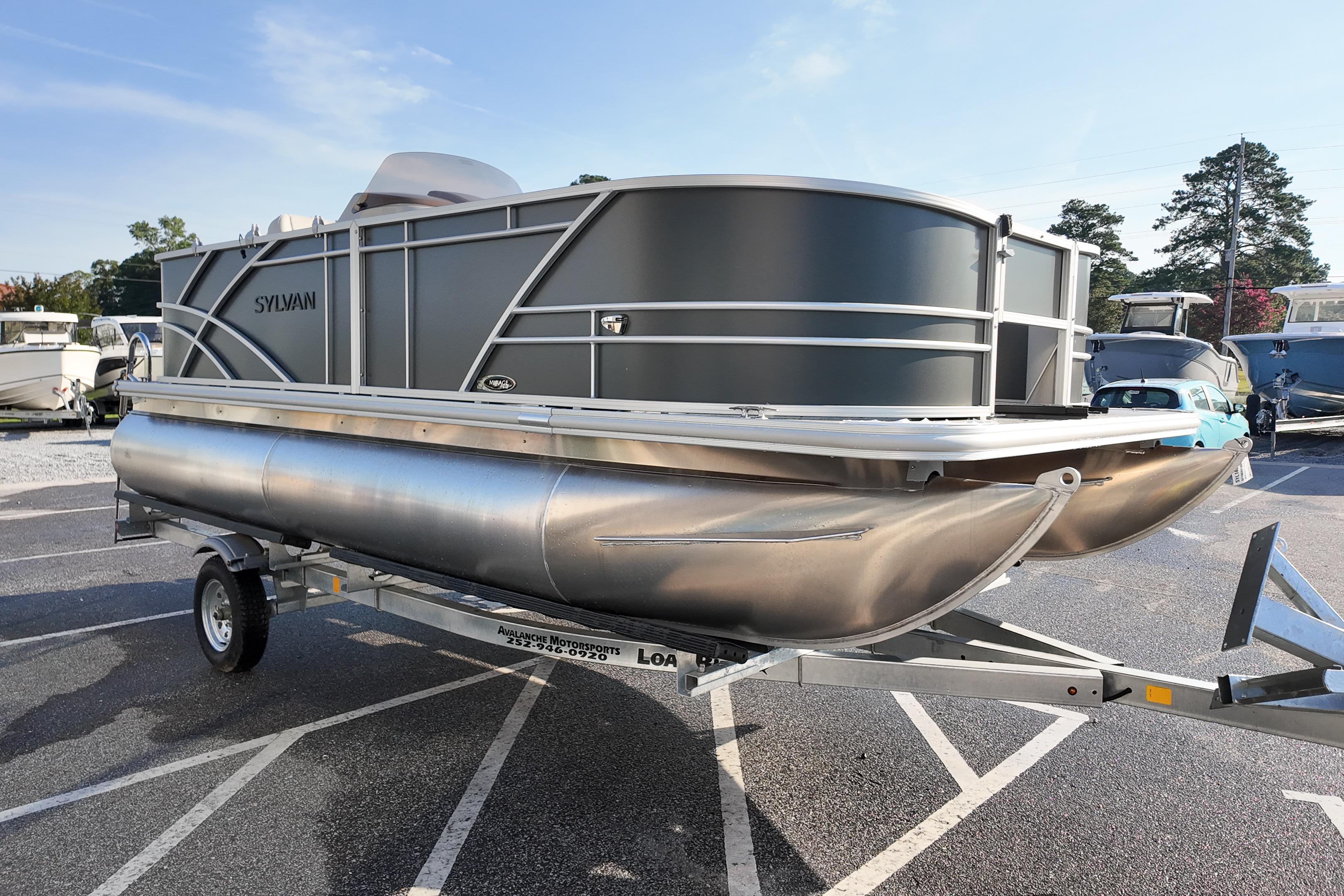 2026 Sylvan Mirage 818 Fish pontoon boat on trailer in parking lot.