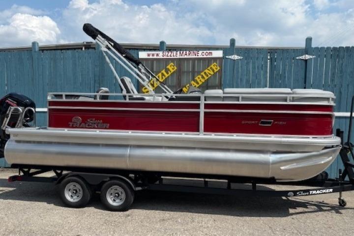 2026 Sun Tracker SportFish 20 DLX pontoon boat on trailer, red and silver design.