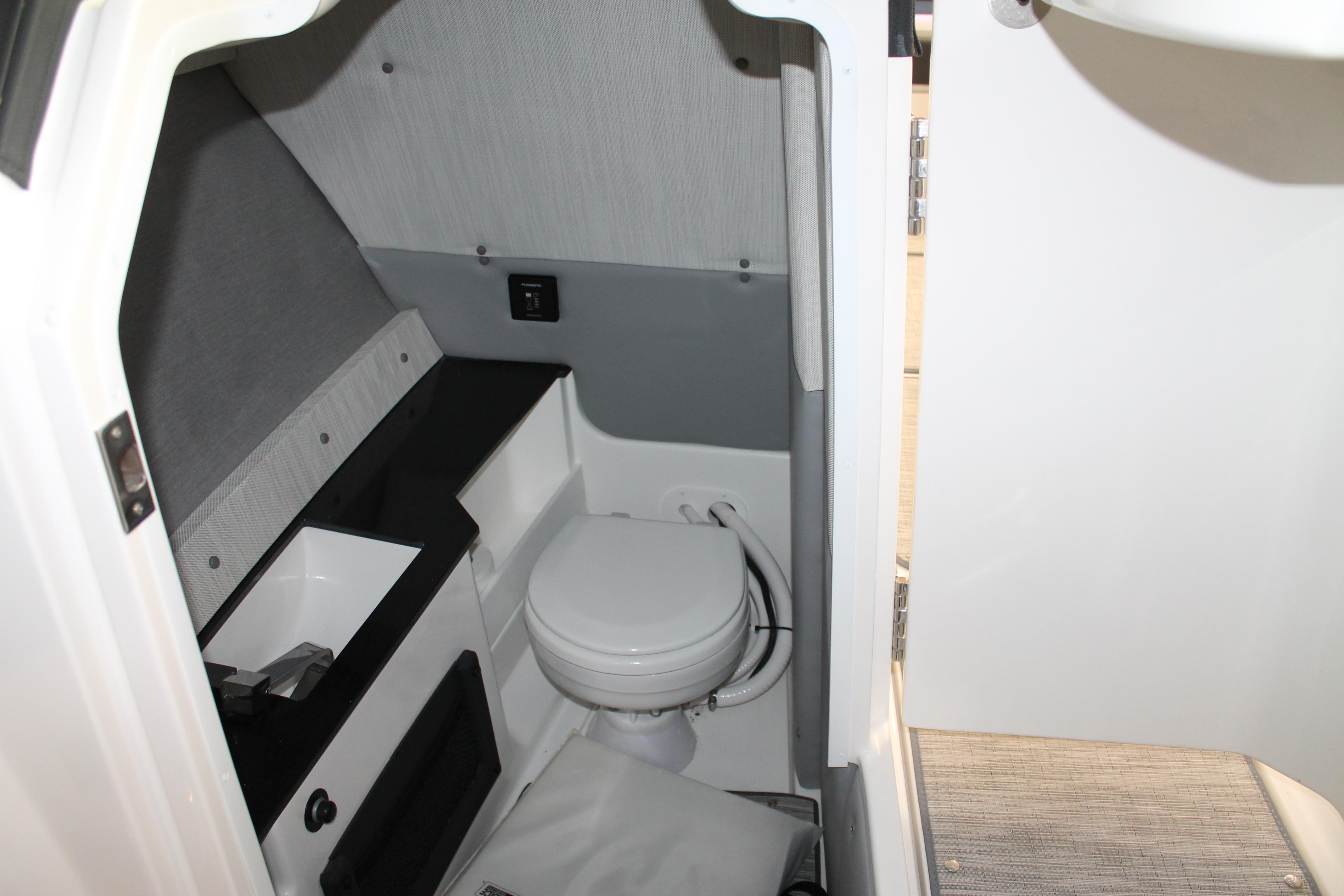 2023 Cobalt R8 boat interior bathroom with modern design and compact toilet.