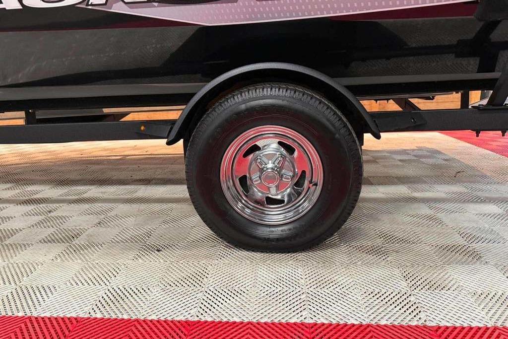 2024 Tracker Pro Team 175 trailer wheel on patterned flooring.