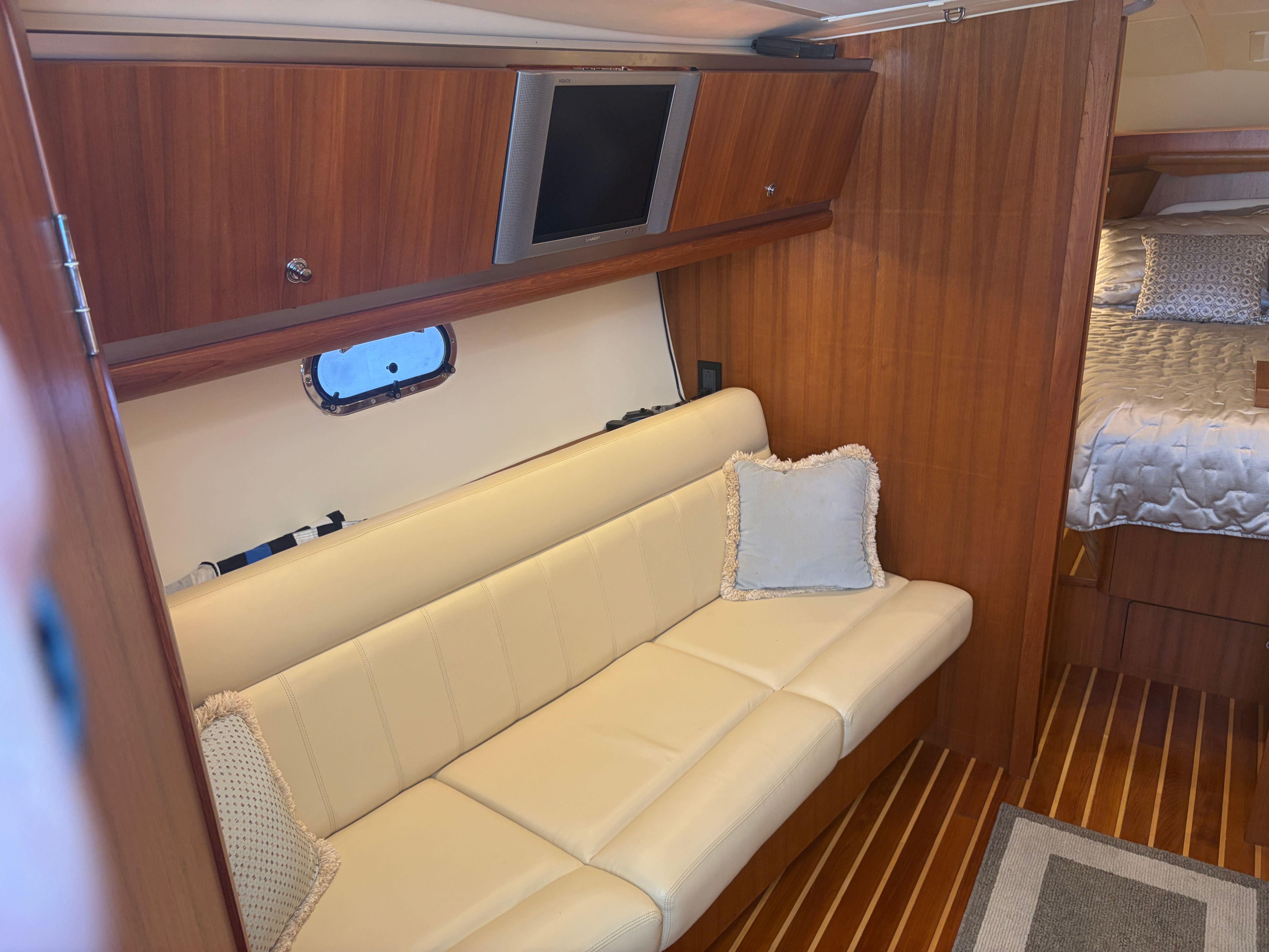 Interior of a 2005 Tiara Yachts Sovran with sofa and bed.