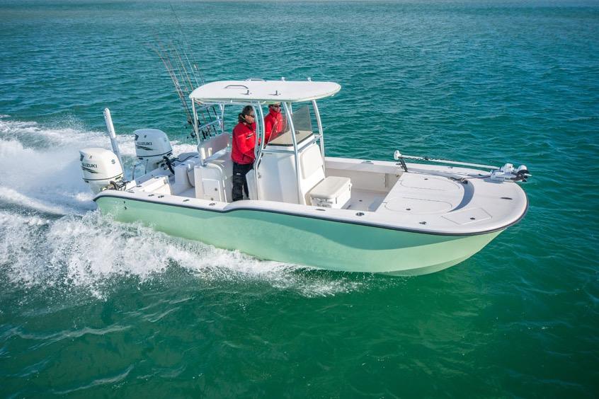 2026 Tideline 235 Hybrid boat cruising on clear blue water.