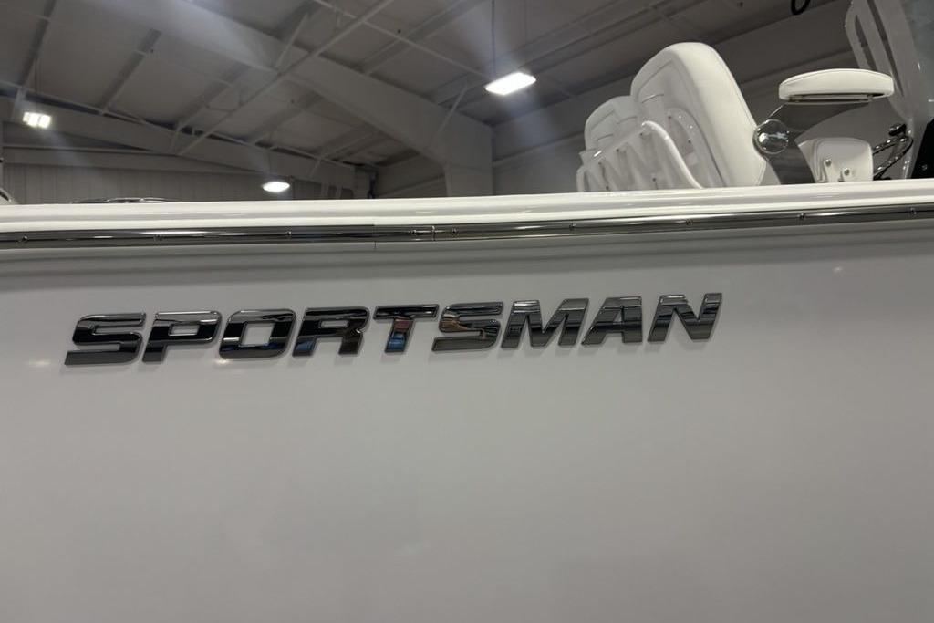 2026 Sportsman Open 252 Center Console boat in showroom, featuring sleek design.