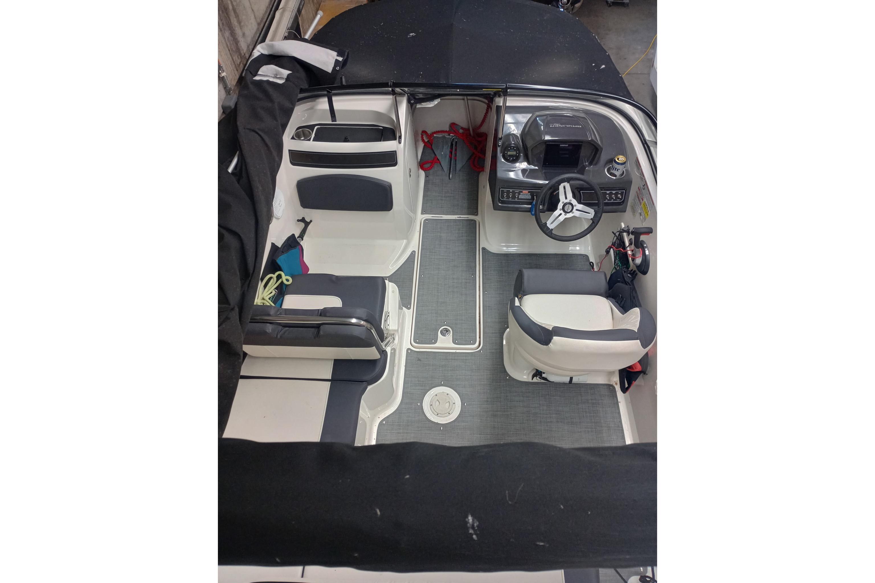2022 Bayliner VR5 Bowrider I/O interior with steering wheel and seating arrangement.