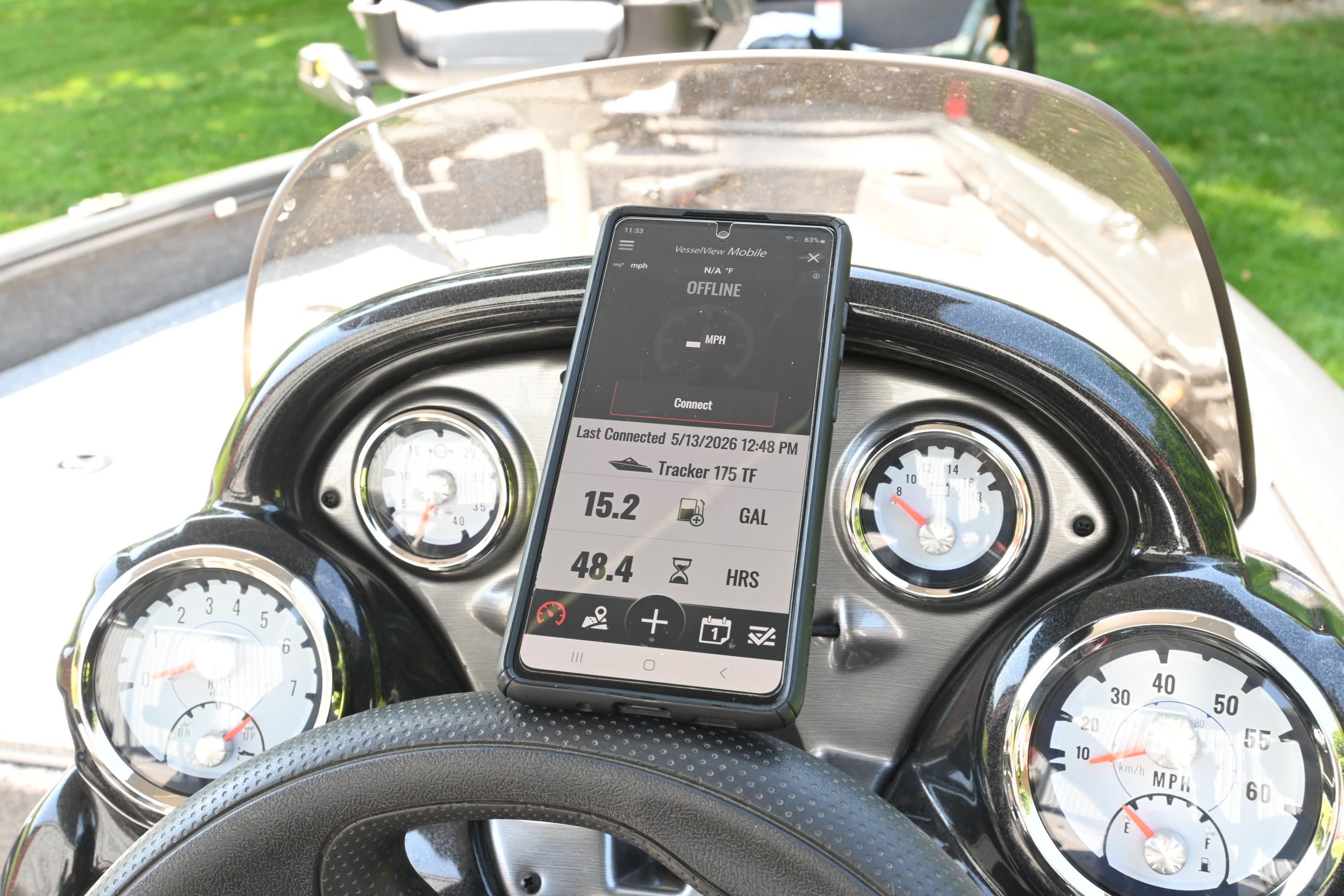 Dashboard of a Tracker Pro 175 TF boat with smartphone.