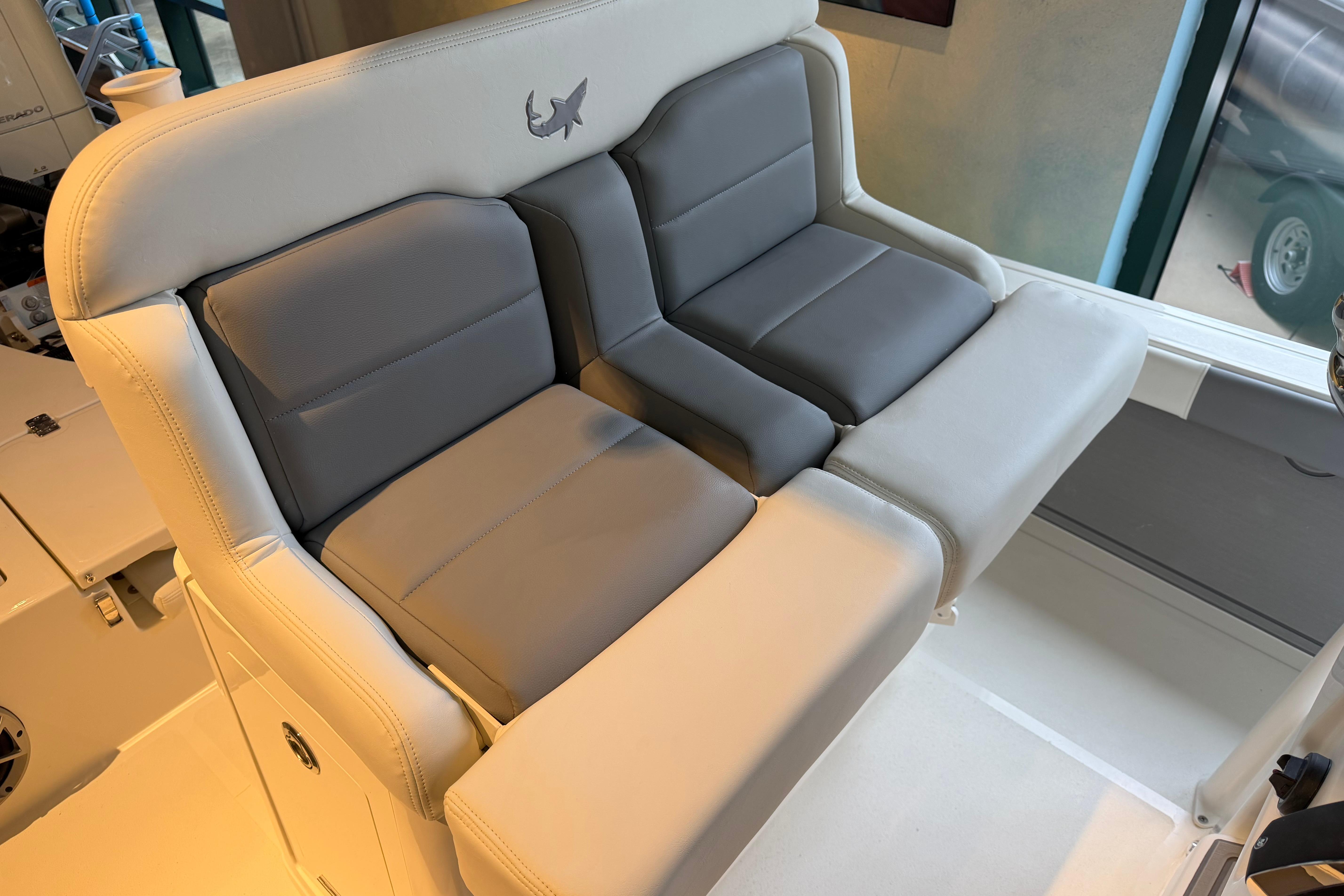 2026 Mako 24 APEX boat seating with gray and white cushioned design.