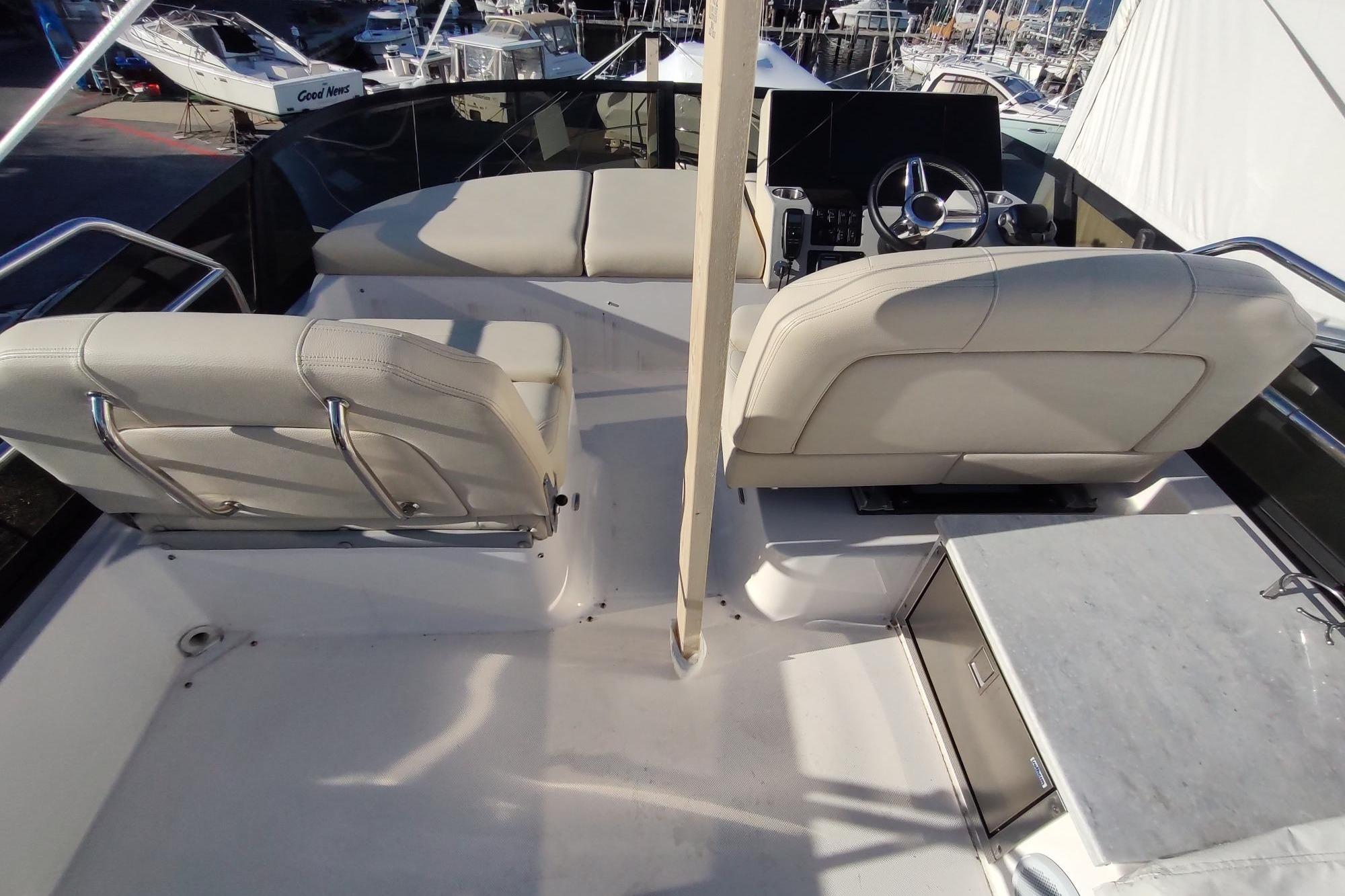 Flybridge of 2021 Regal 42 Fly yacht with helm and seating area.