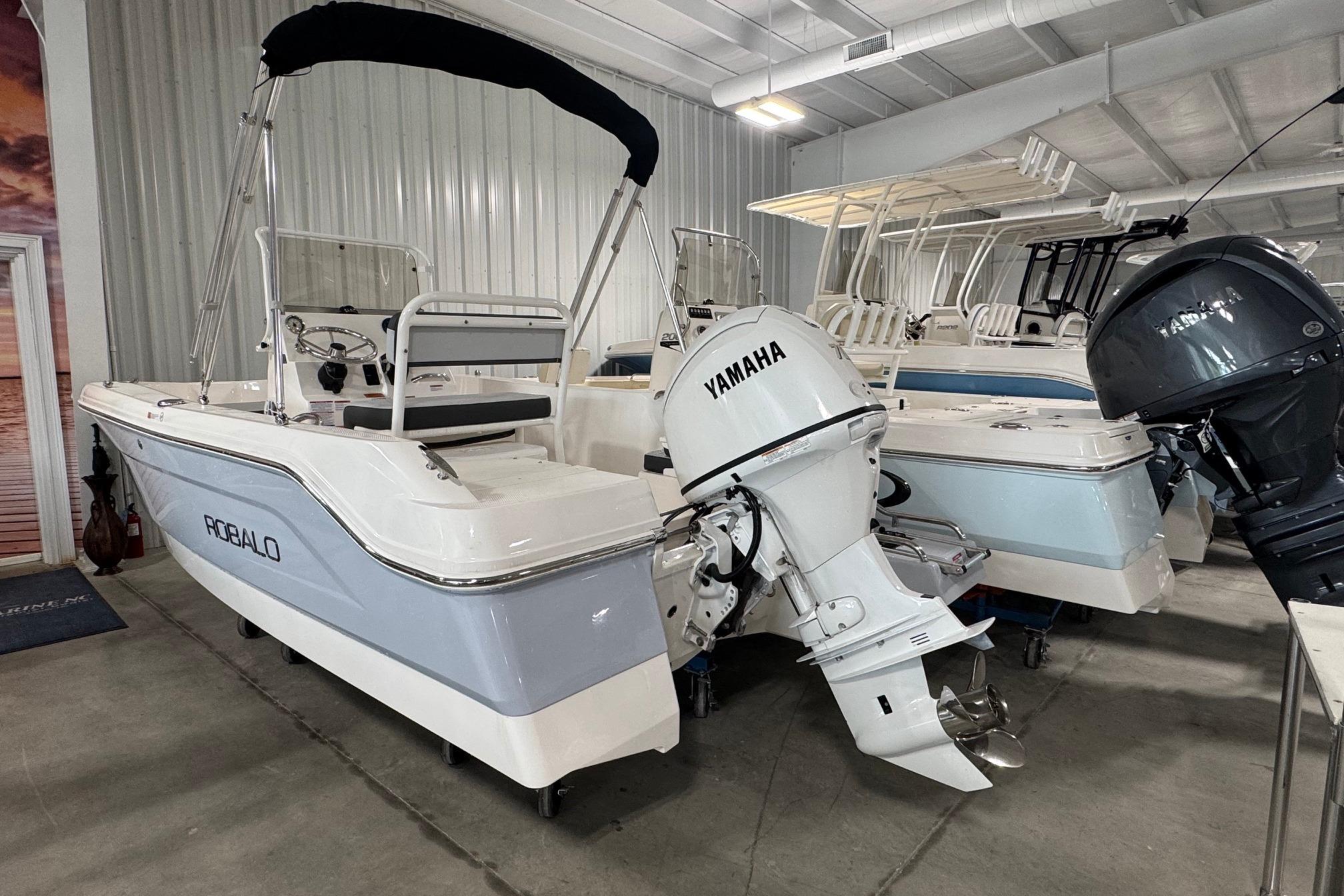 2026 Robalo R160 Center Console boat with Yamaha outboard in showroom.