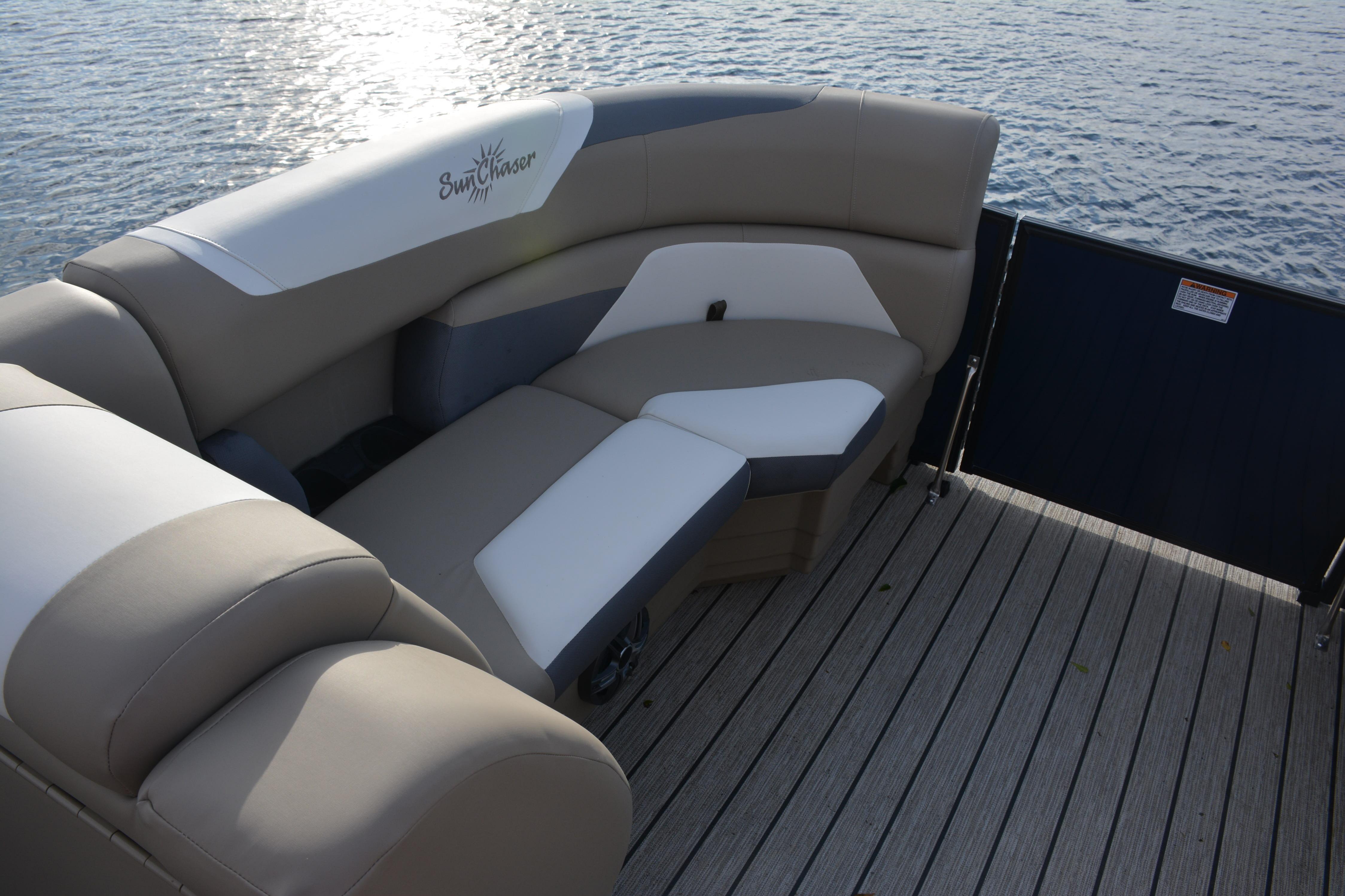 Luxurious seating on 2026 SunChaser Eclipse 25 LR DH pontoon boat, overlooking serene water.