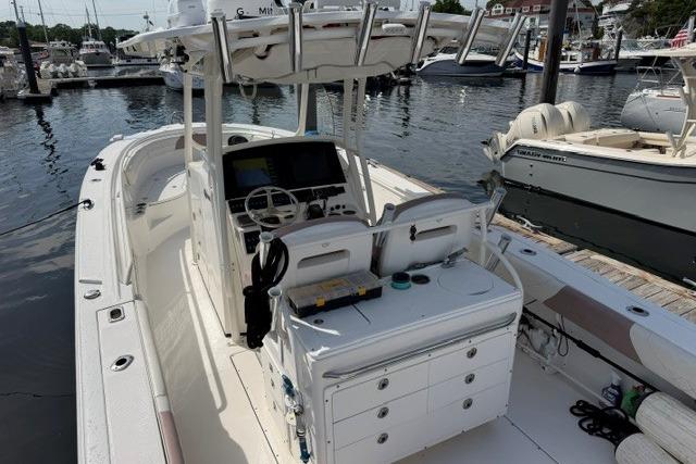 2014 Edgewater 318CC boat docked at marina, featuring spacious deck and modern controls.
